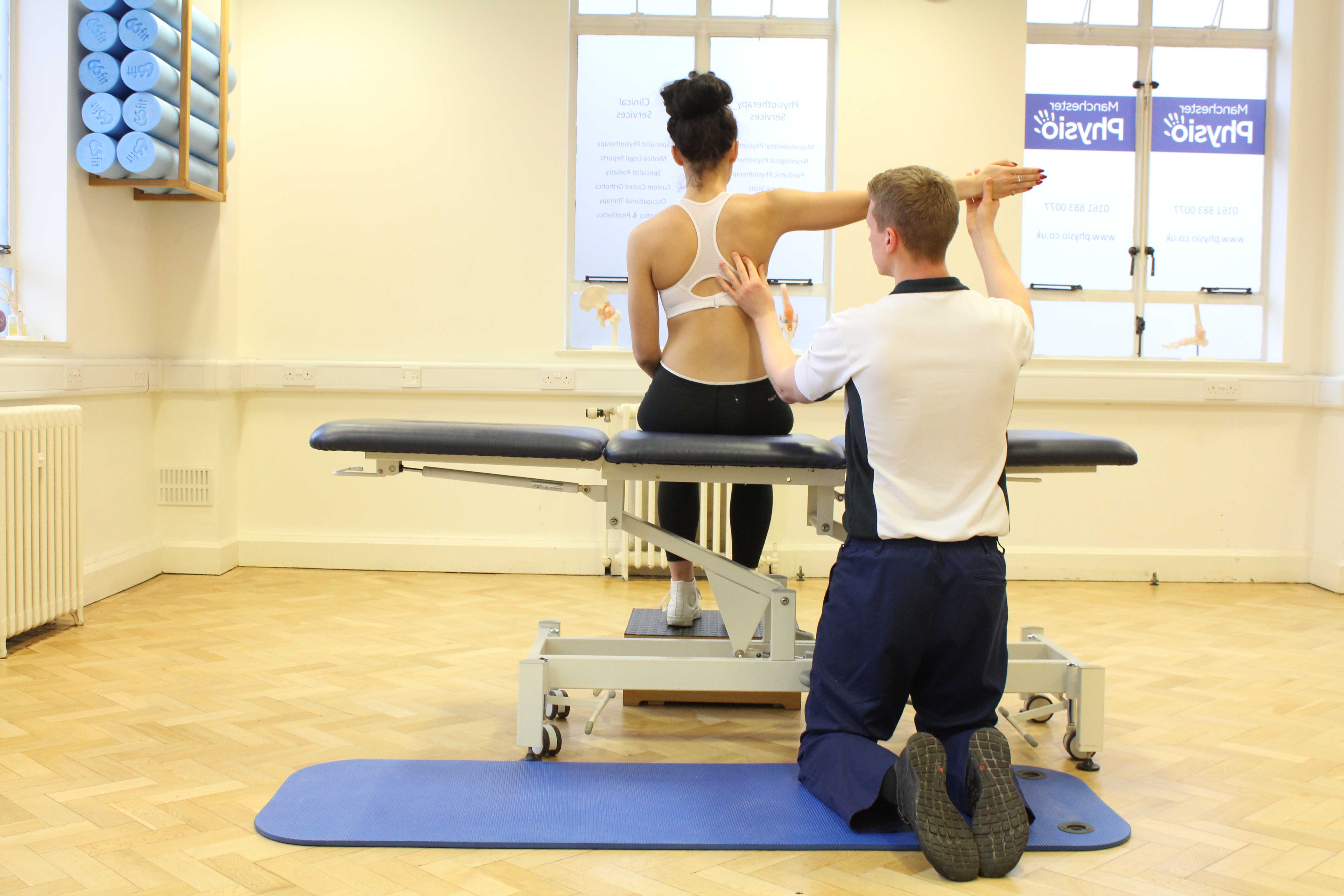 Experienced physiotherapist assessing underlying cause of persistant shoulder pain
