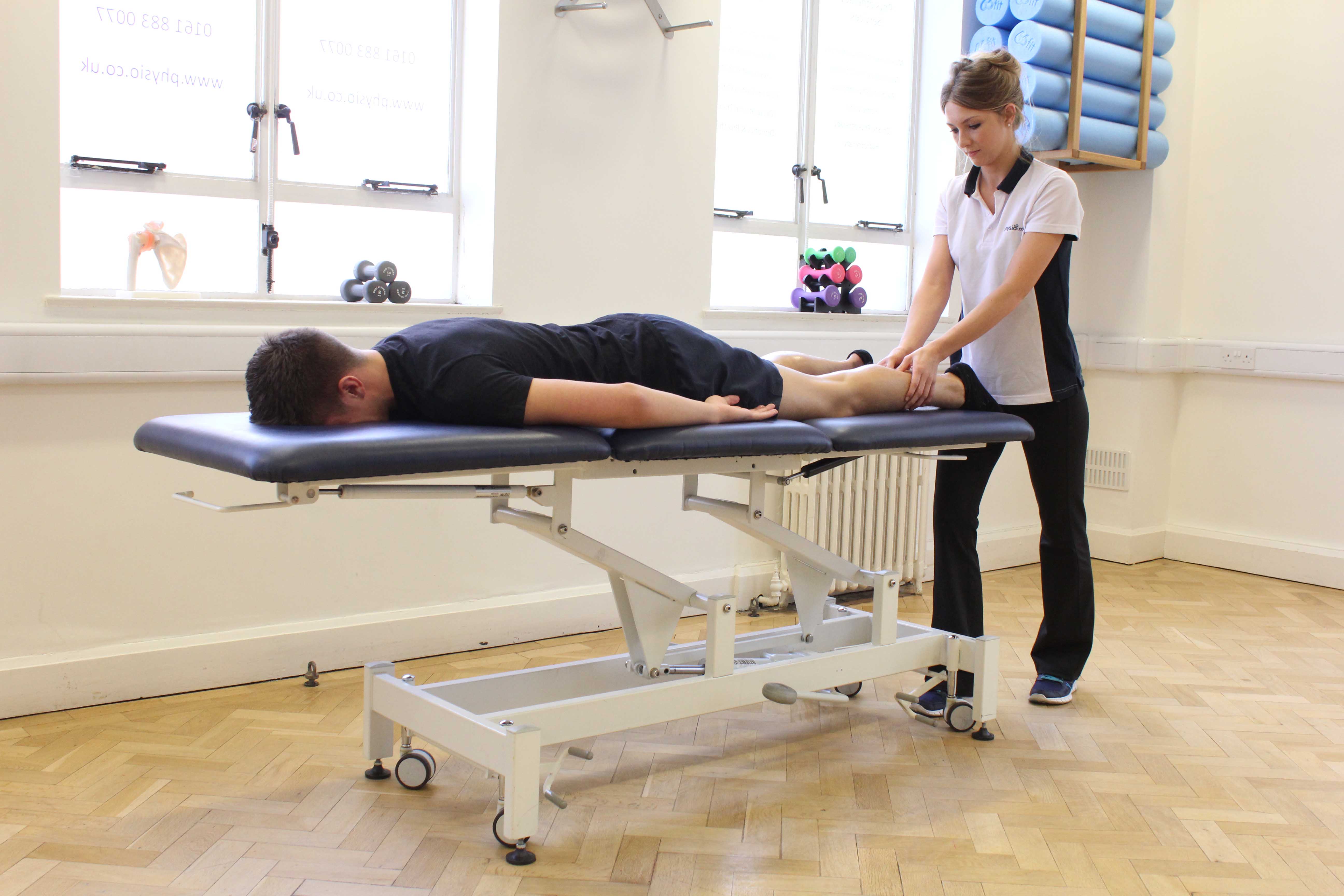 Trigger point massage technique applied to the gastroc nemius muscle to relieve pain and stiffness