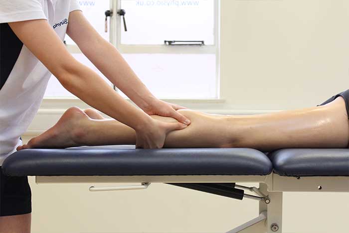 Customer receiving calf massage while in a relaxed position in Manchester Physio Clinic