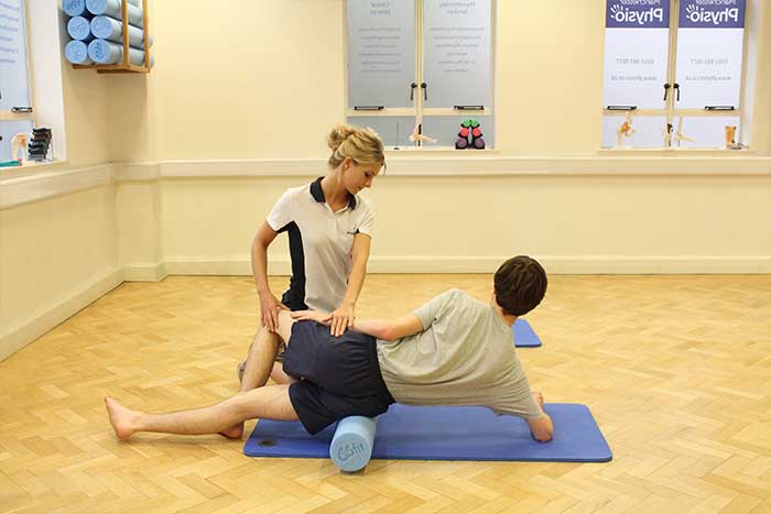 Customer receiving leg muscle stretch treatment in Manchester Physio Clinic