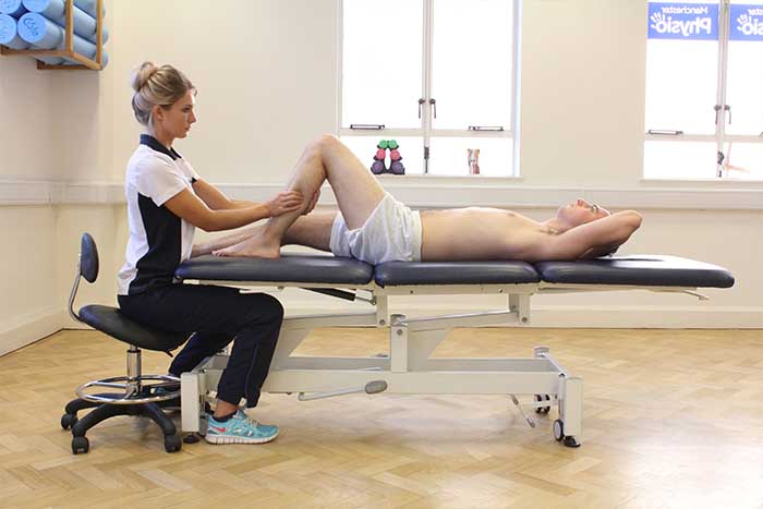 Customer reciving lower leg massage in Manchester Physio Clinic
