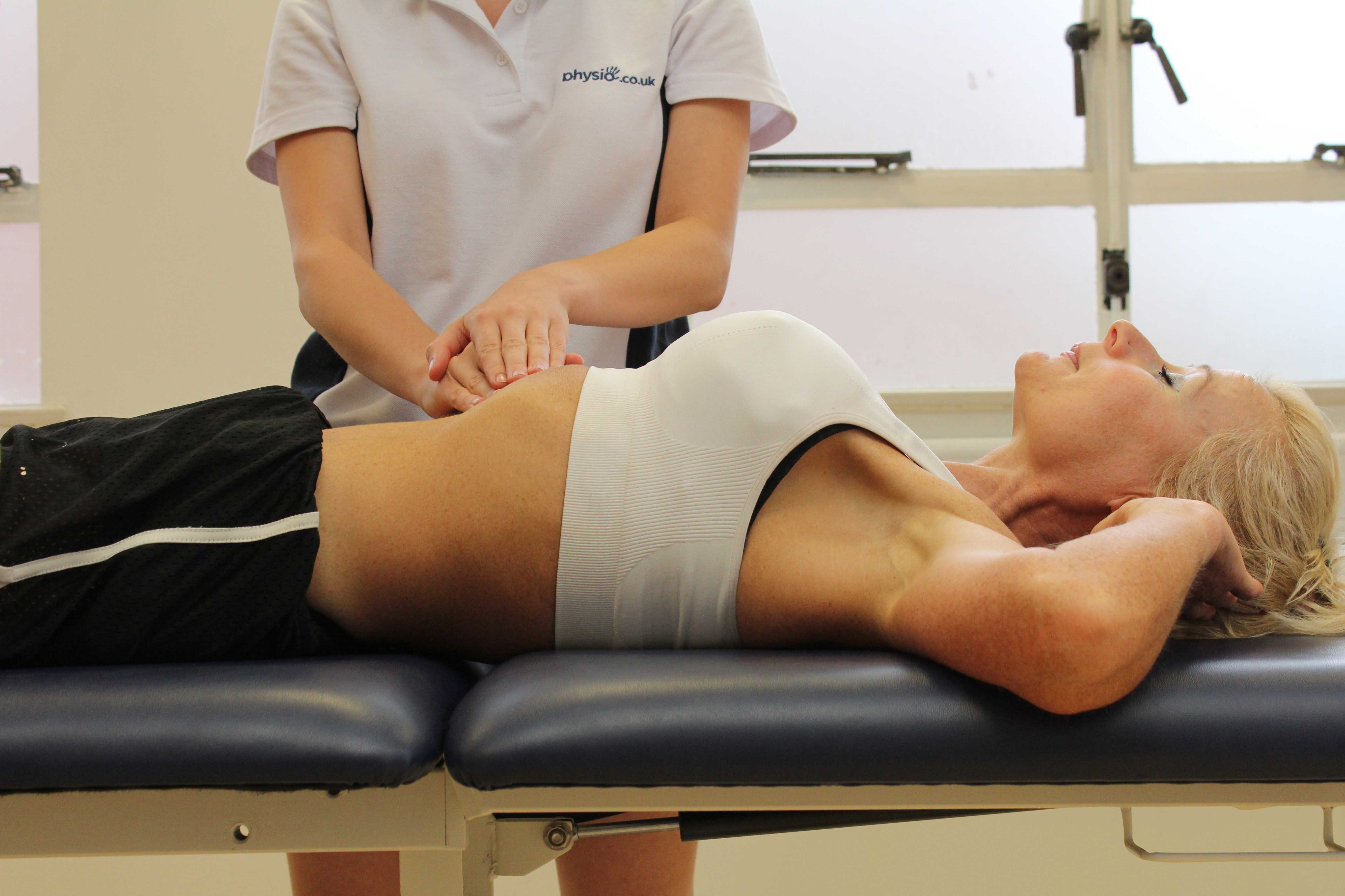 Soft tissue massage of the abdominal muscles by an experienced therapist Soft tissue massage of the abdominal muscles by an experienced therapist