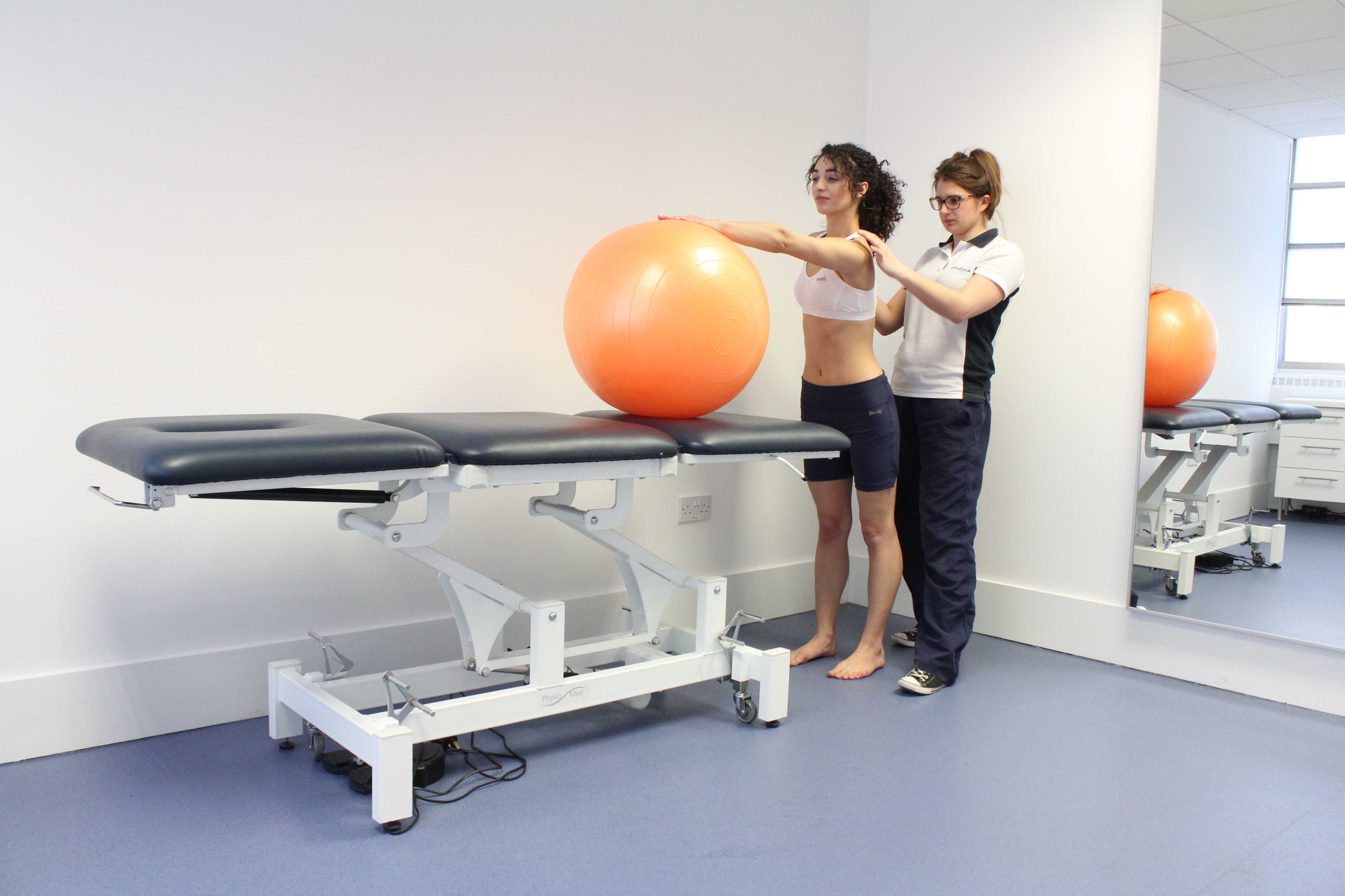 Gym ball assisted shoulder stretches under supervision of physiotherapist