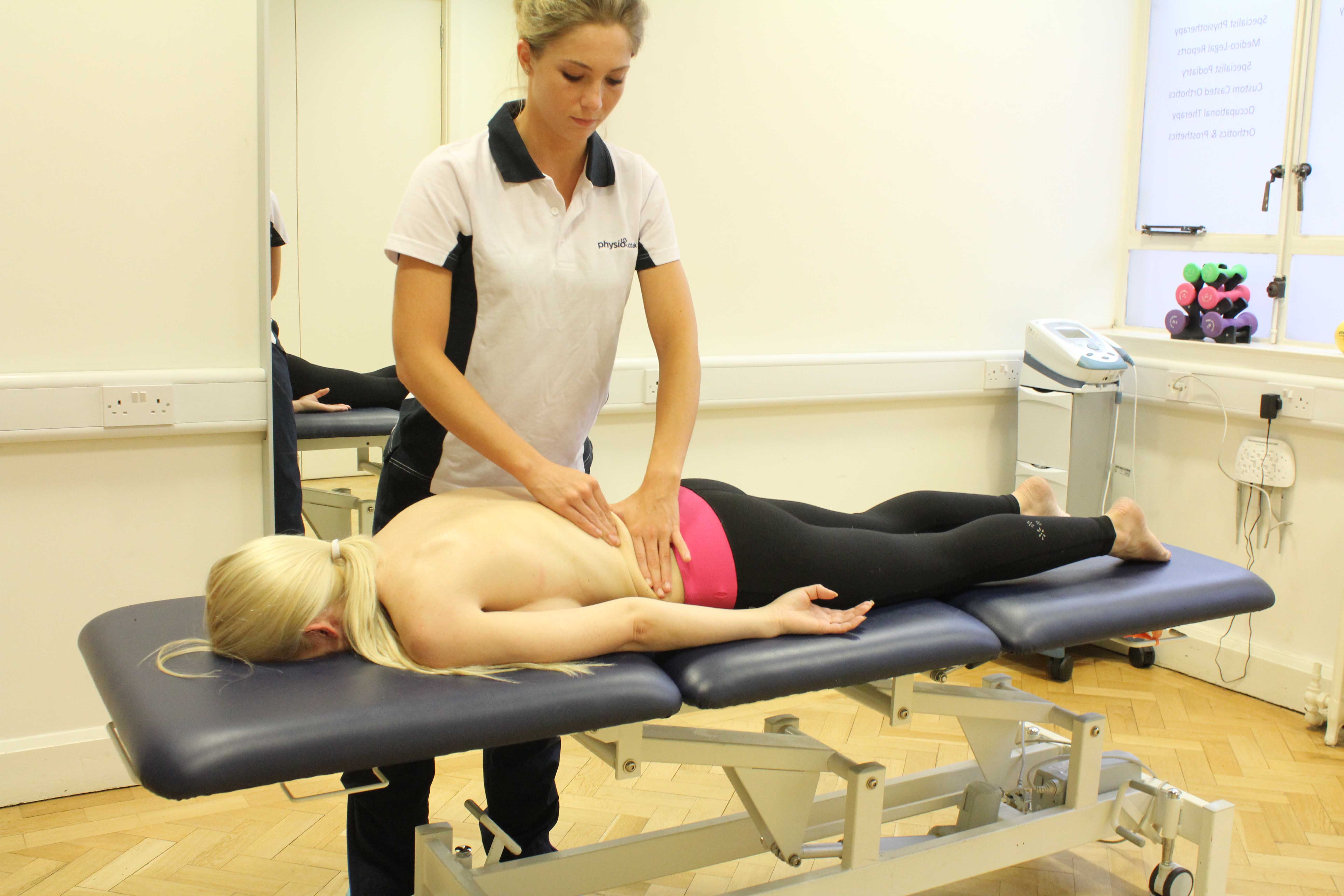Rolling Soft Tissue Massage applied to the lower back by experienced therapist Rolling Soft Tissue Massage applied to the lower back by experienced therapist