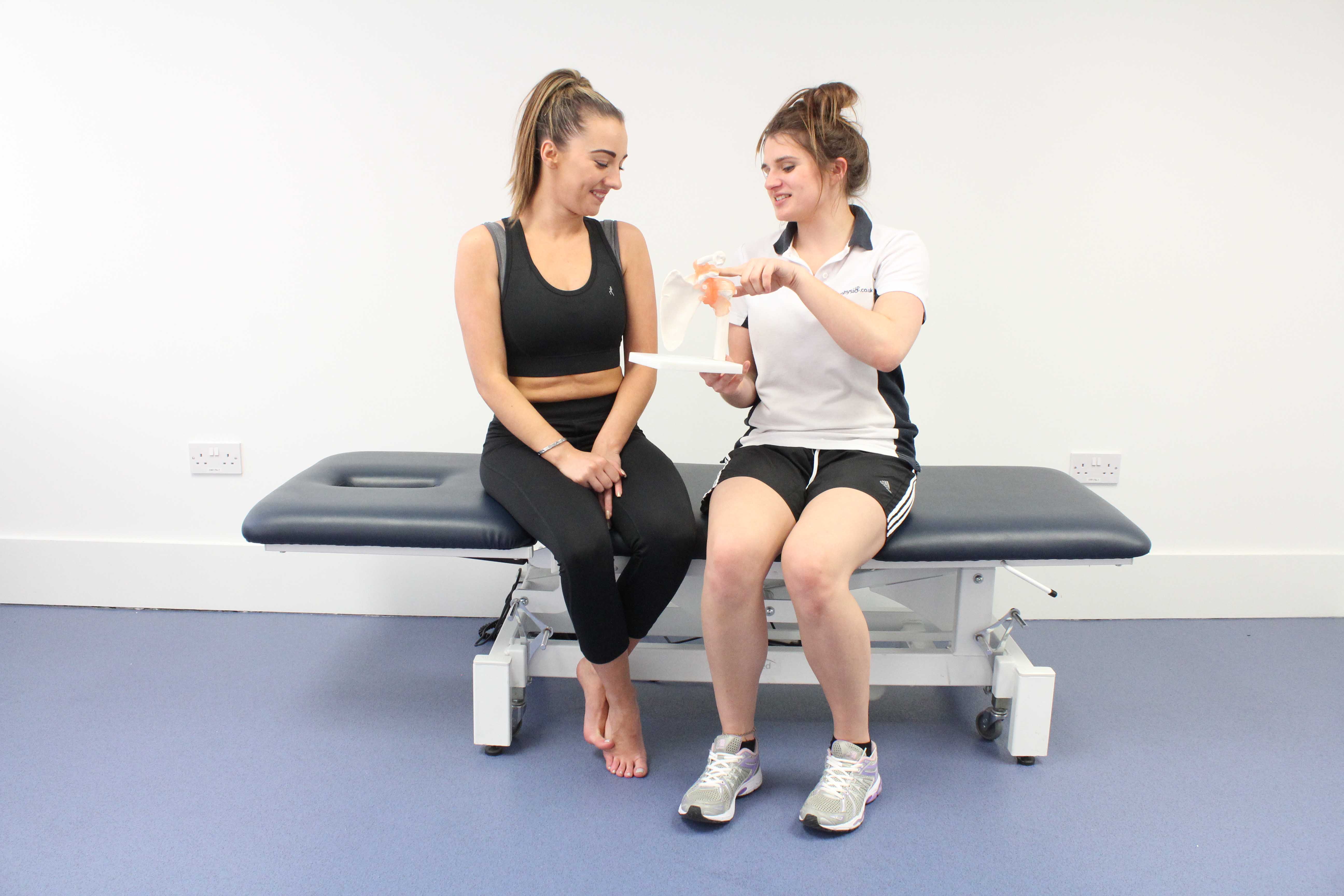 Physiotherapist advising the client about their condition Physiotherapist advising the client about their condition