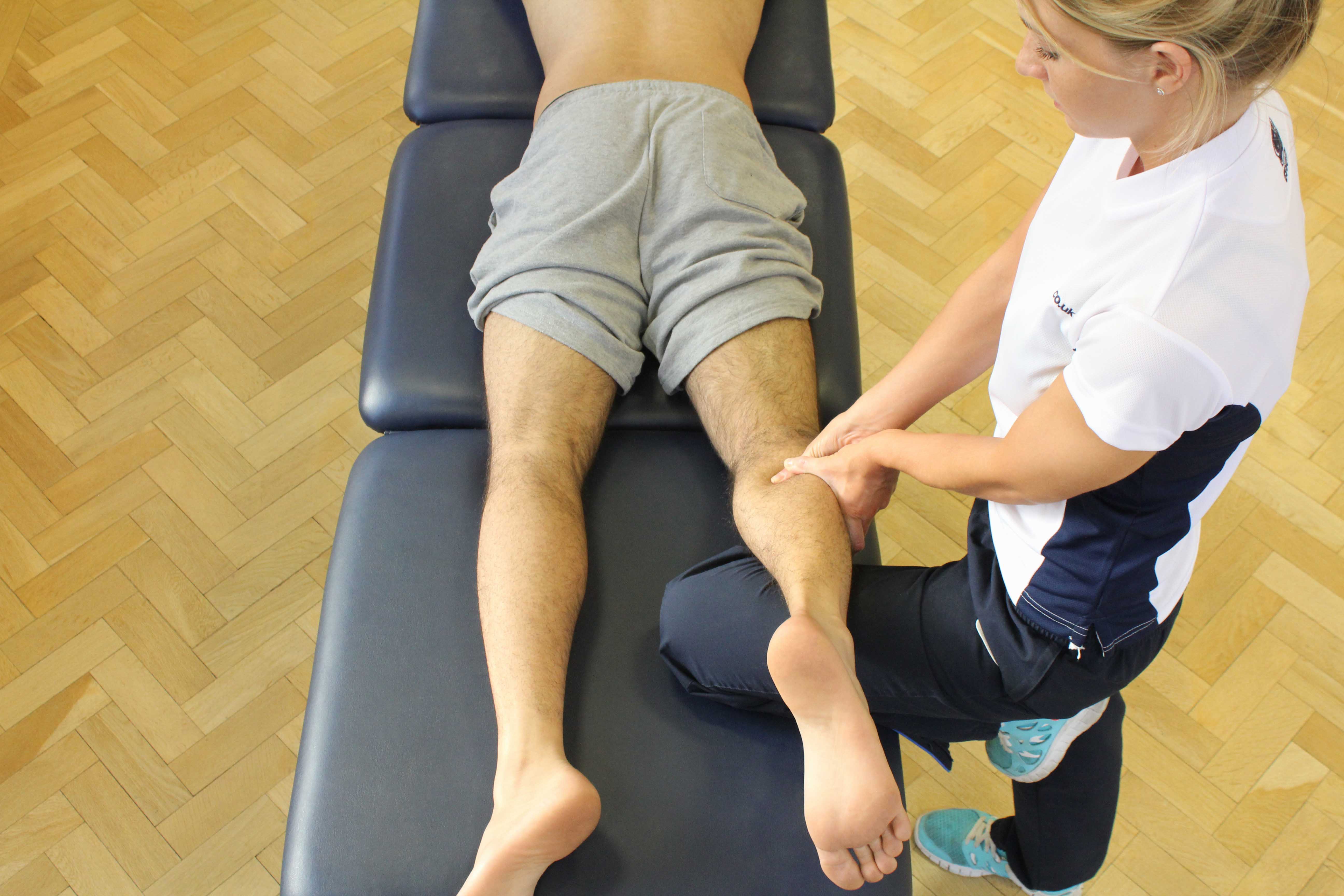 Trigger point massage applied to gastrocnemius muscle by specilaist therapist