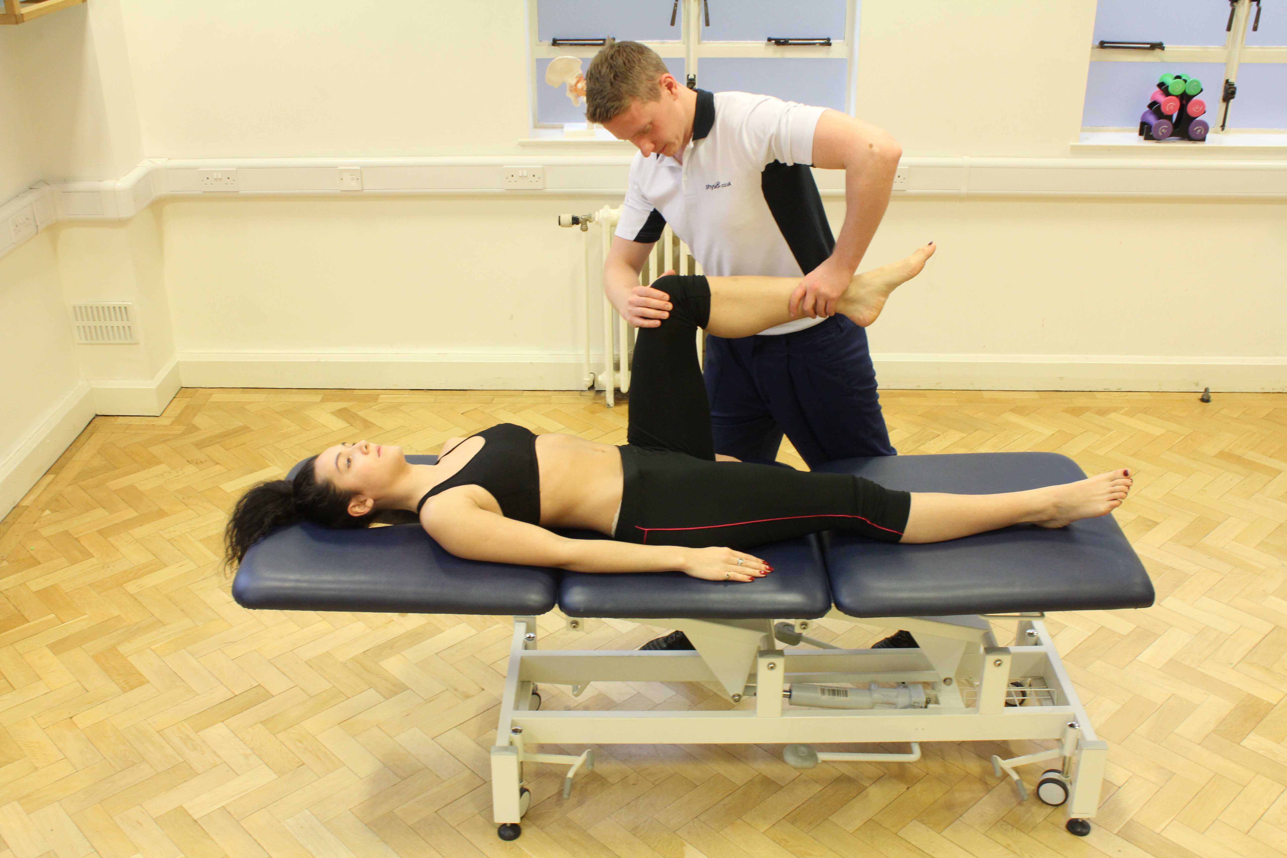 Therapist performing knee assessment