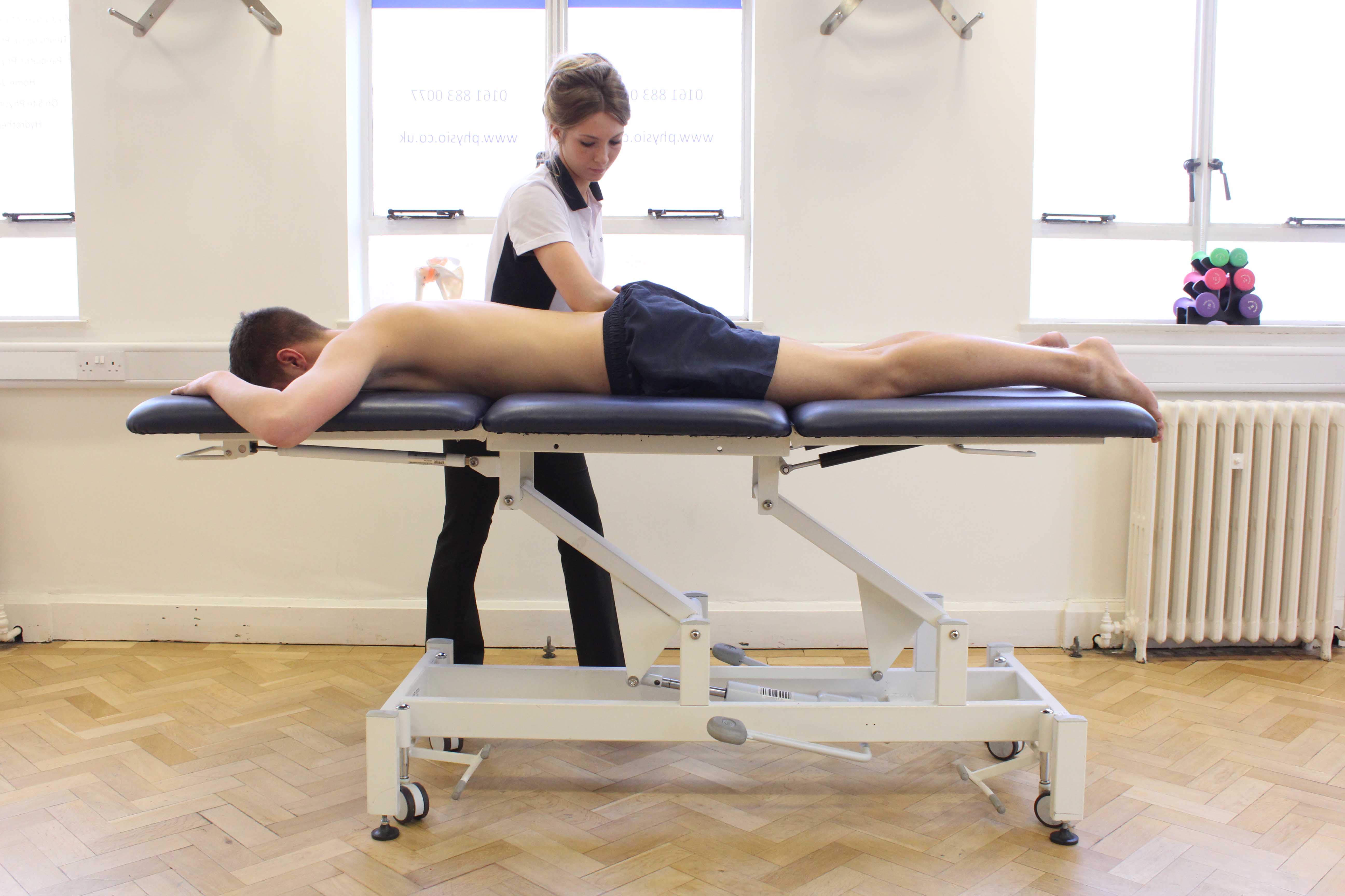 Deep tissue massage of the lower back by a specialist massage therapist