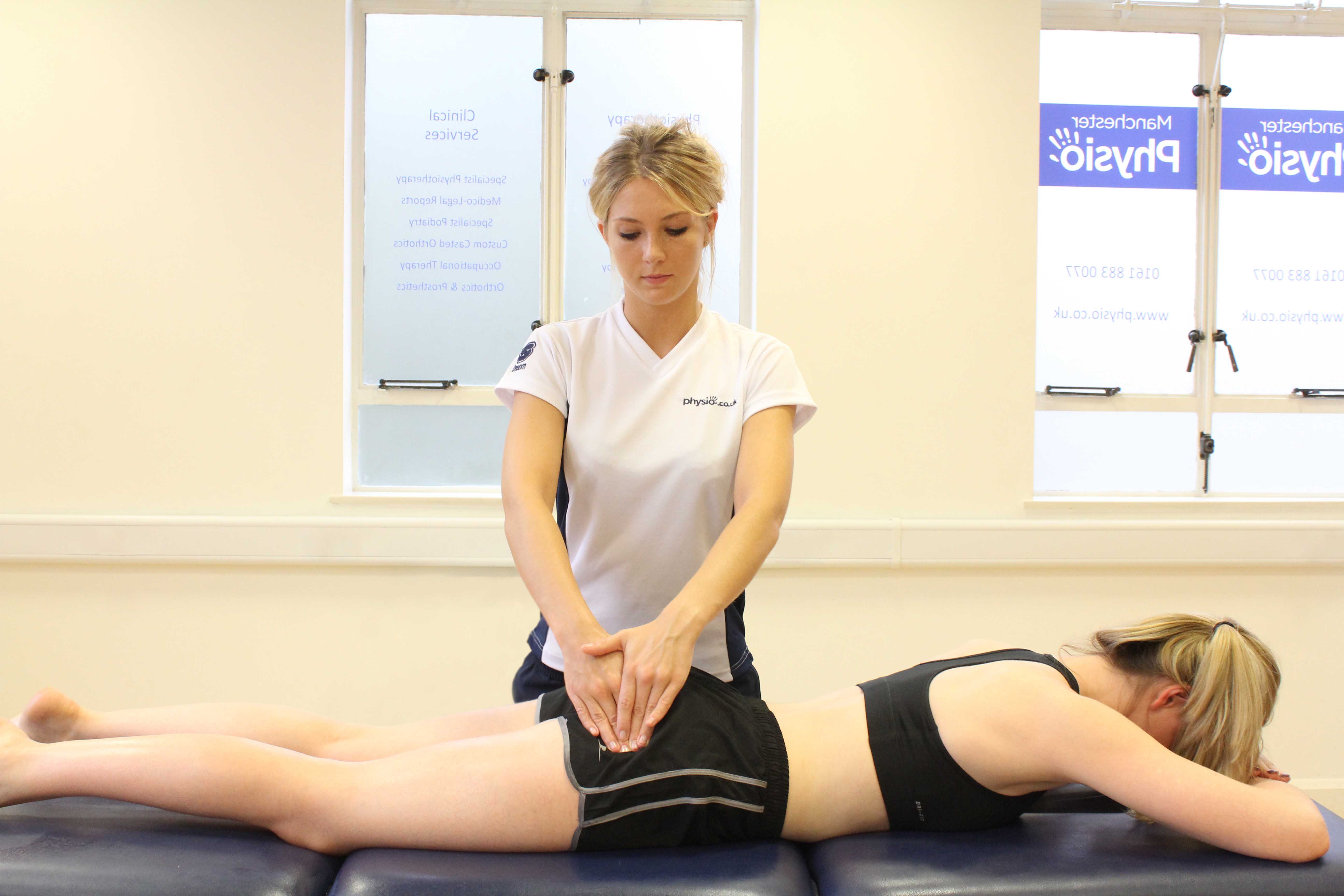 Deep tissue massage of the gluteus muscle by experienced therapist
