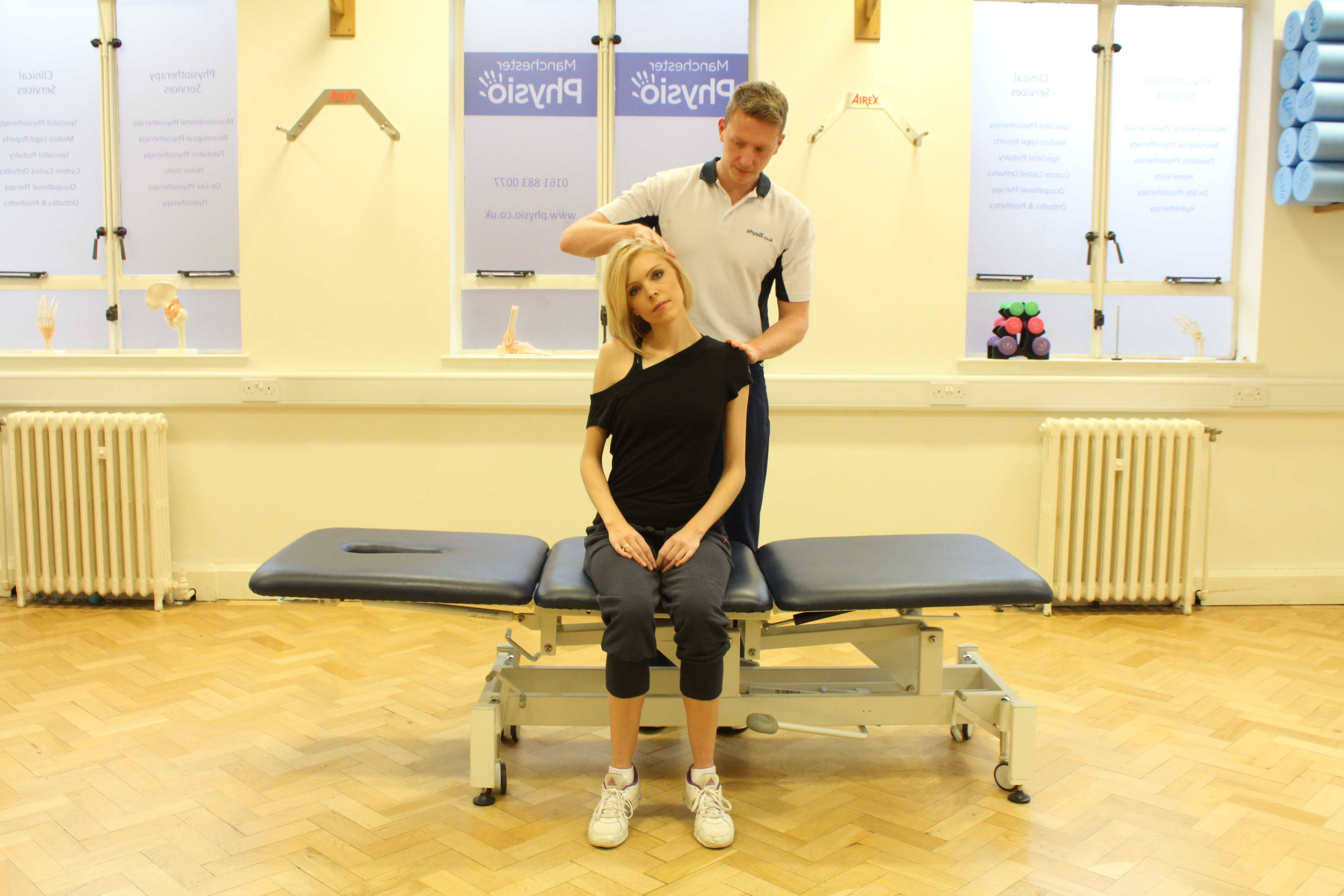 Experienced Physiotherapist conducting an assessment of the cervical spine, muscles and connective tissues in the neck