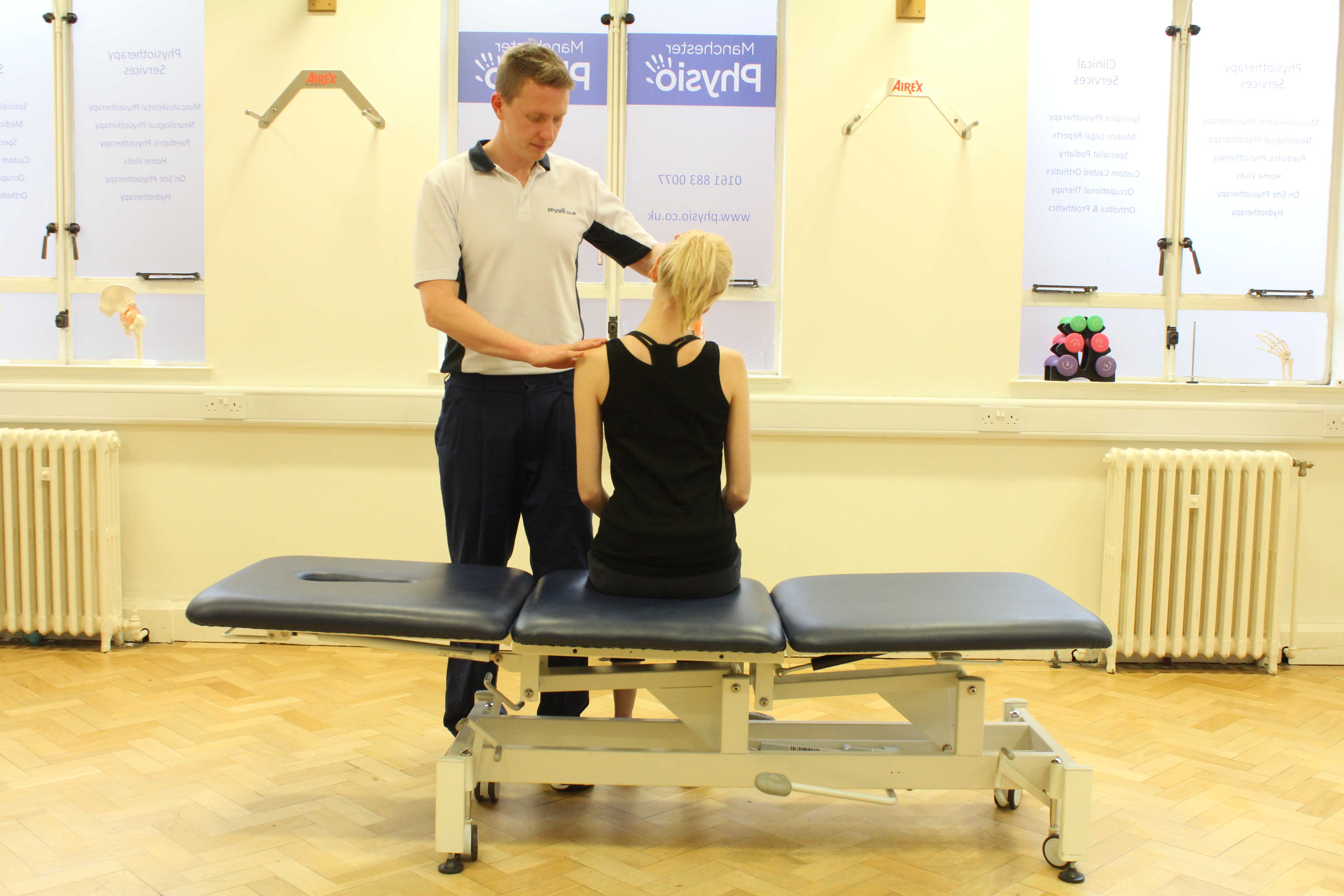 Experienced Physiotherapist conducting an assessment of the cervical spine, muscles and connective tissues in the neck