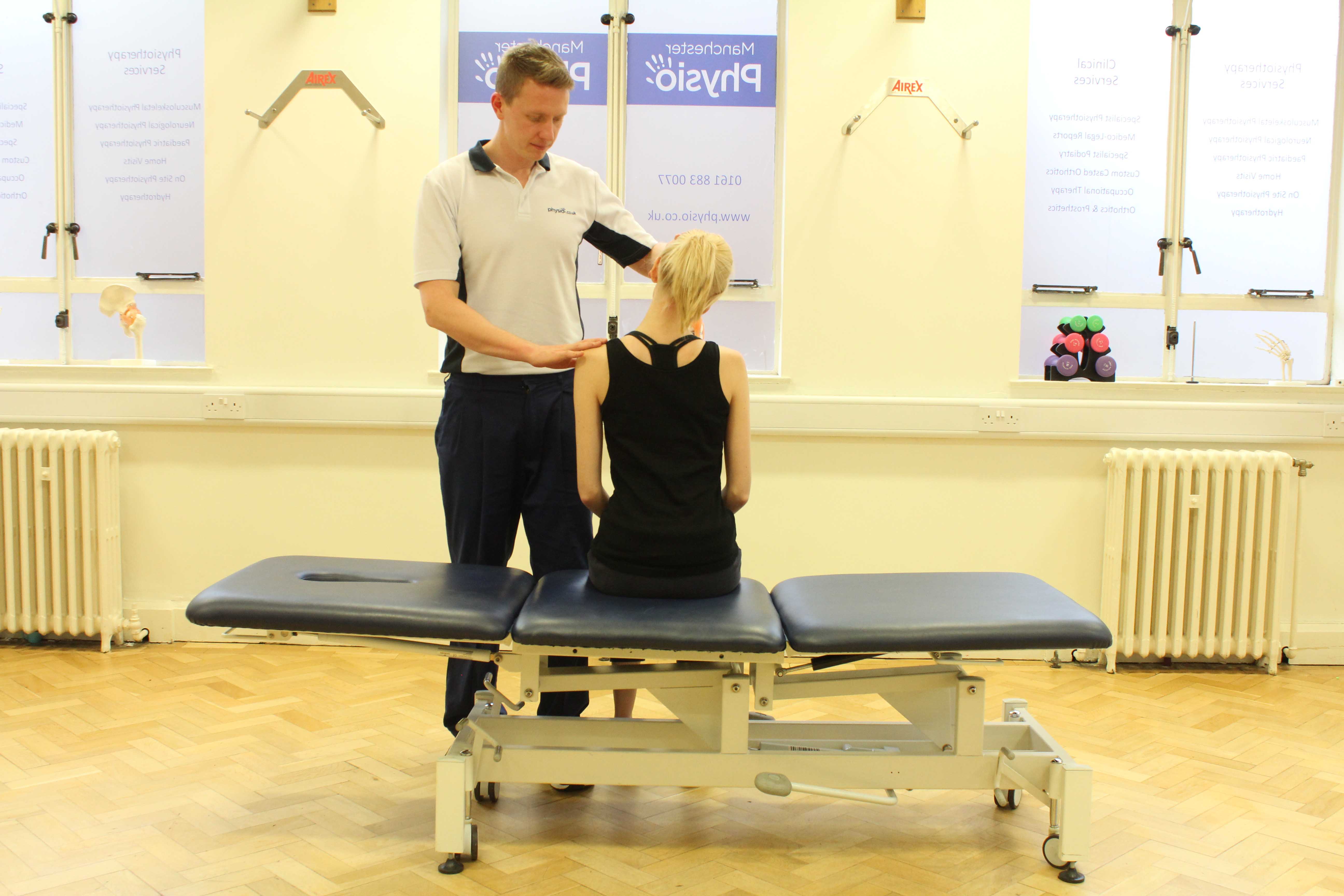 Experienced Physiotherapist conducting an assessment of the cervical spine, muscles and connective tissues in the neck Experienced Physiotherapist conducting an assessment of the cervical spine, muscles and connective tissues in the neck