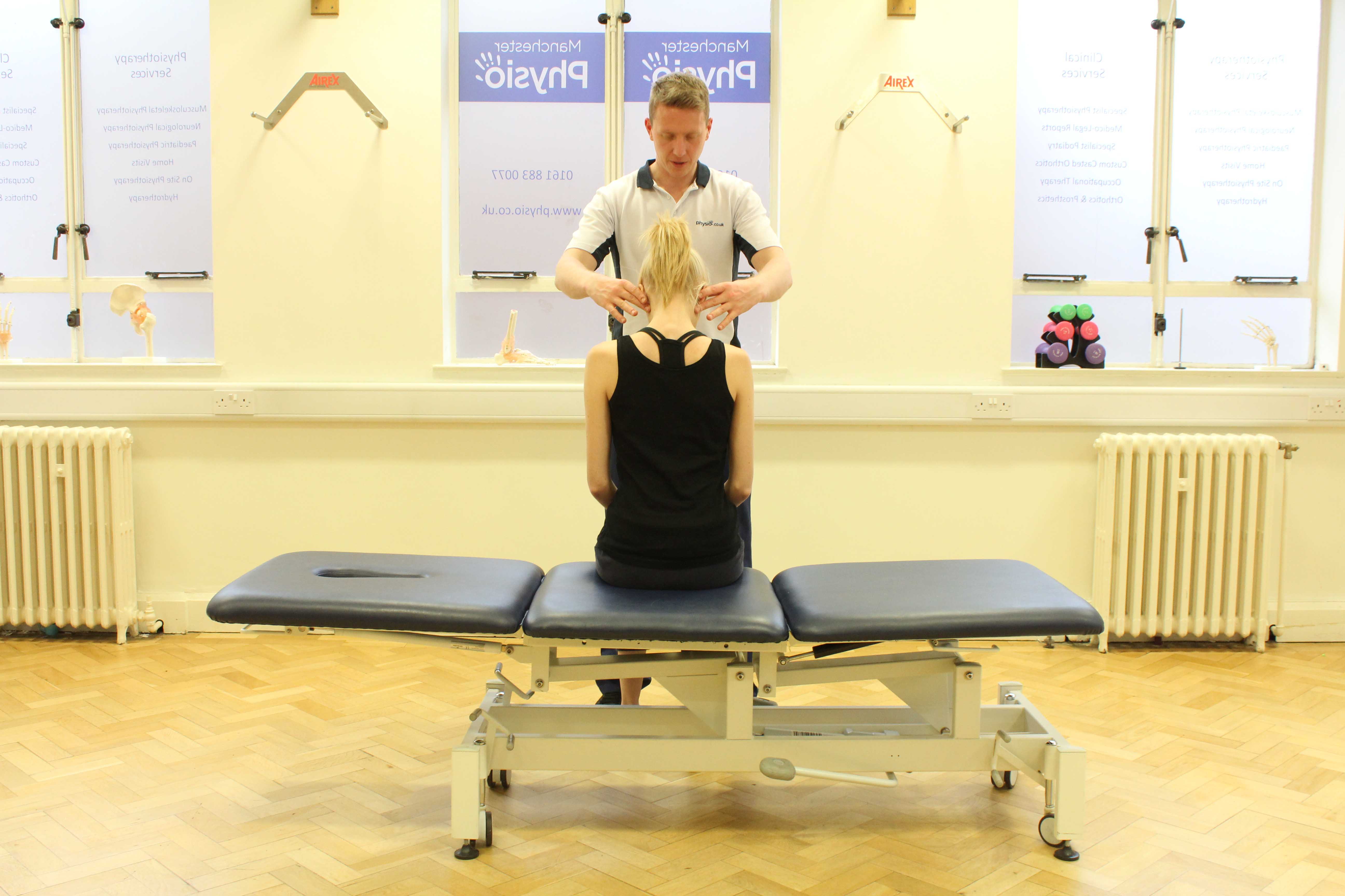 Experienced Physiotherapist conducting an assessment of the cervical spine, muscles and connective tissues in the neck