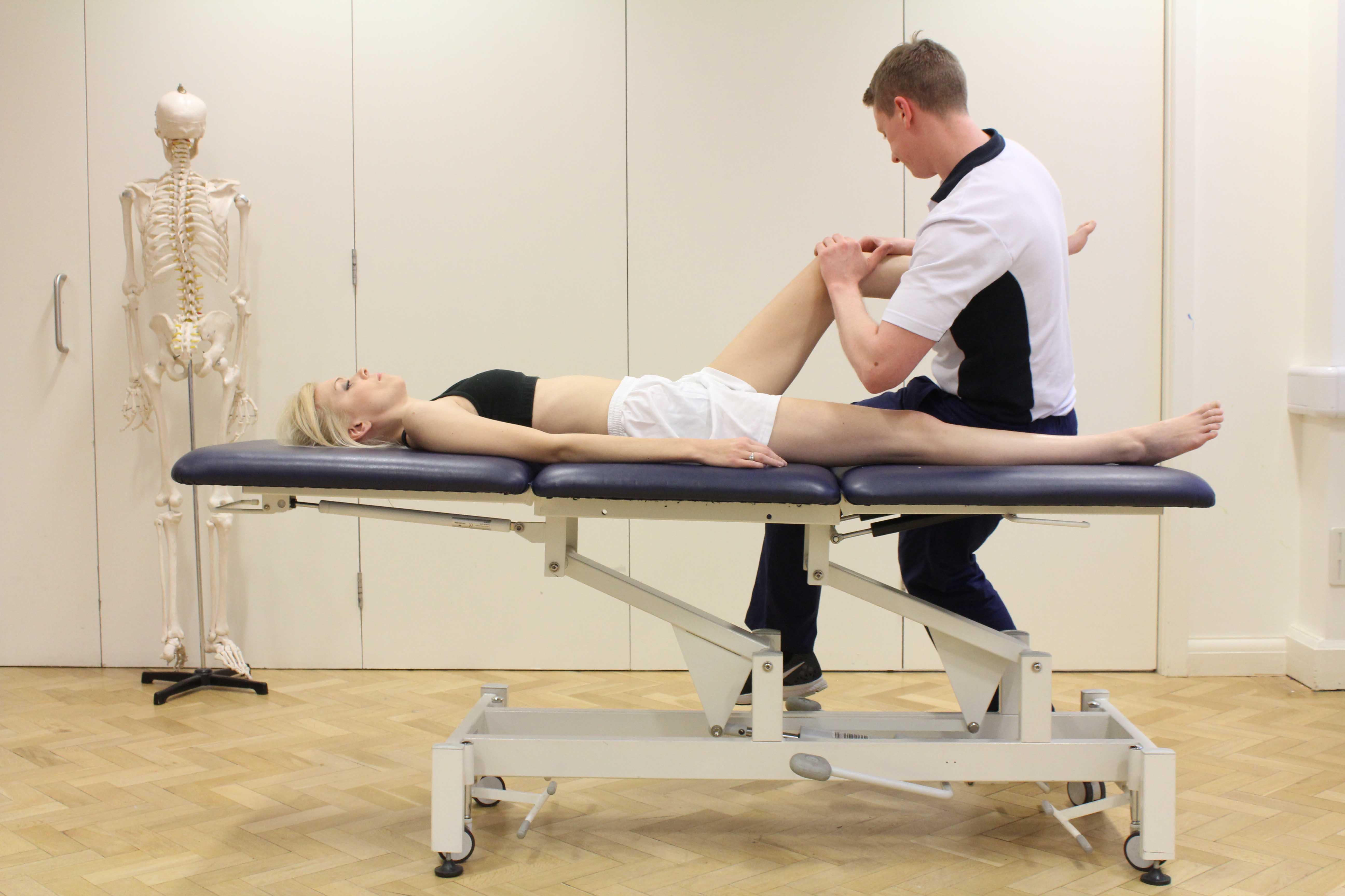 Therapist performing knee assessment