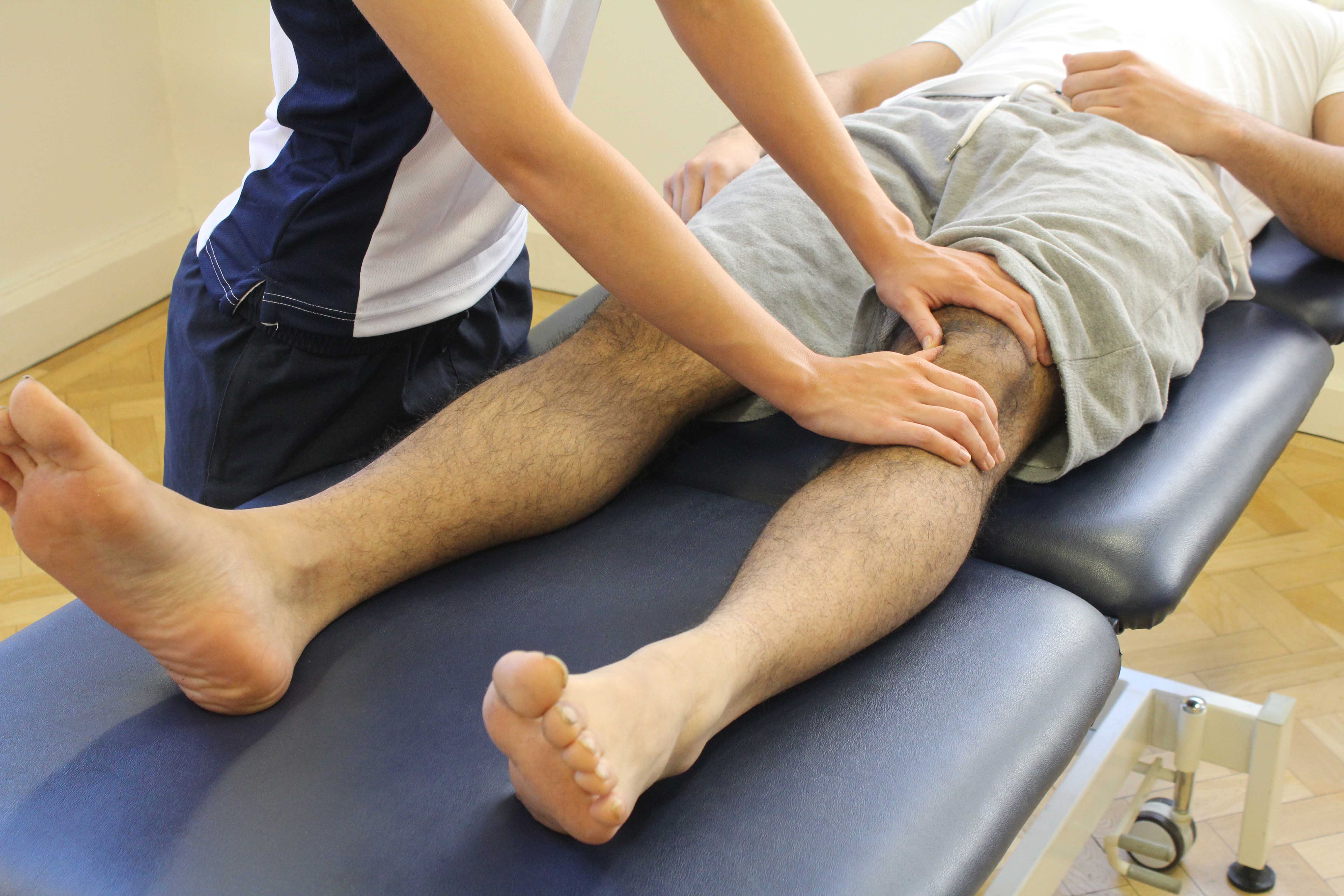 Therapist performing soft tissue massage and mobilisations on the patella and surrounding connective tissue.