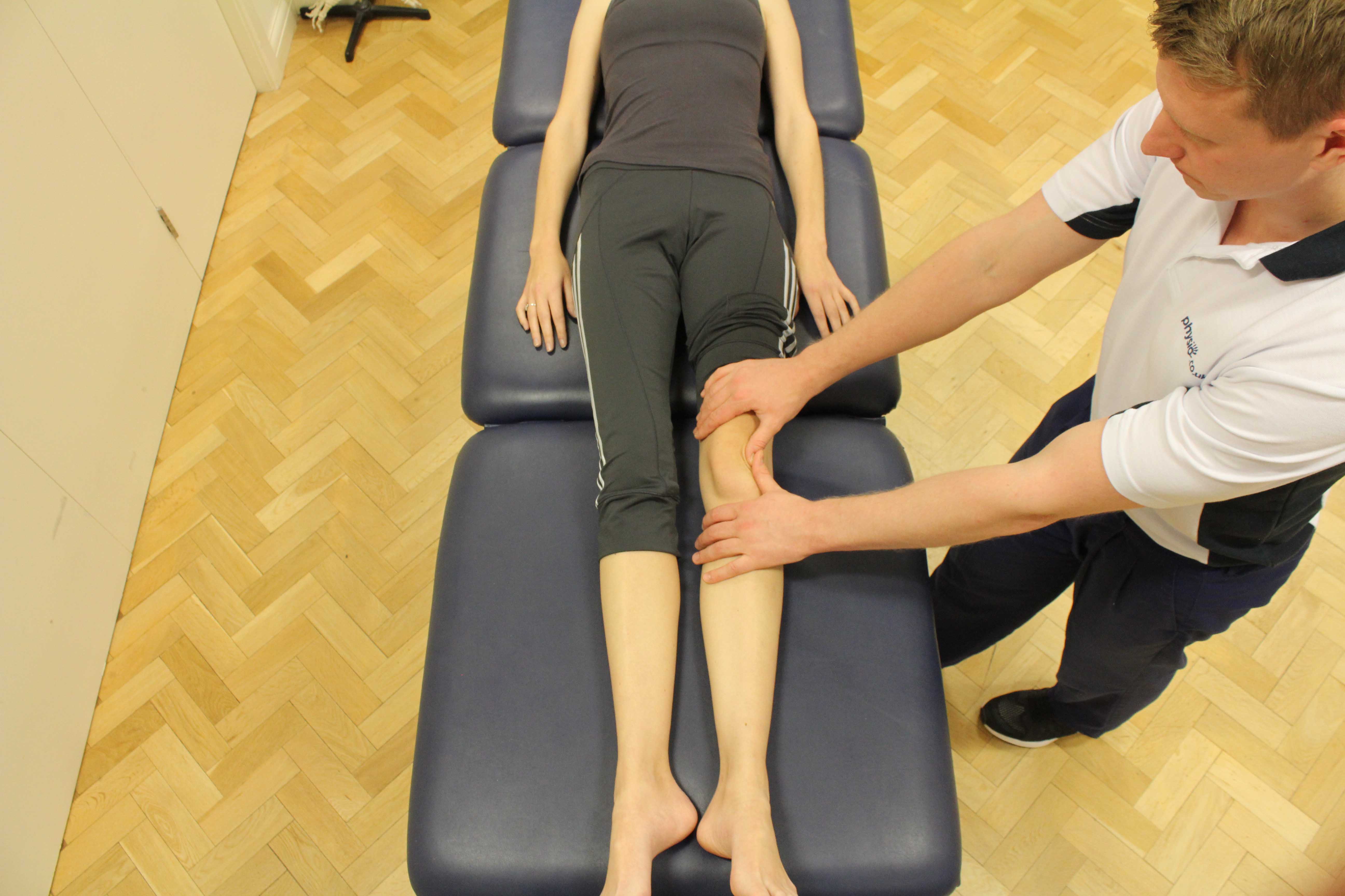 Therapist performing soft tissue massage and mobilisations on the patella and surrounding connective tissue.