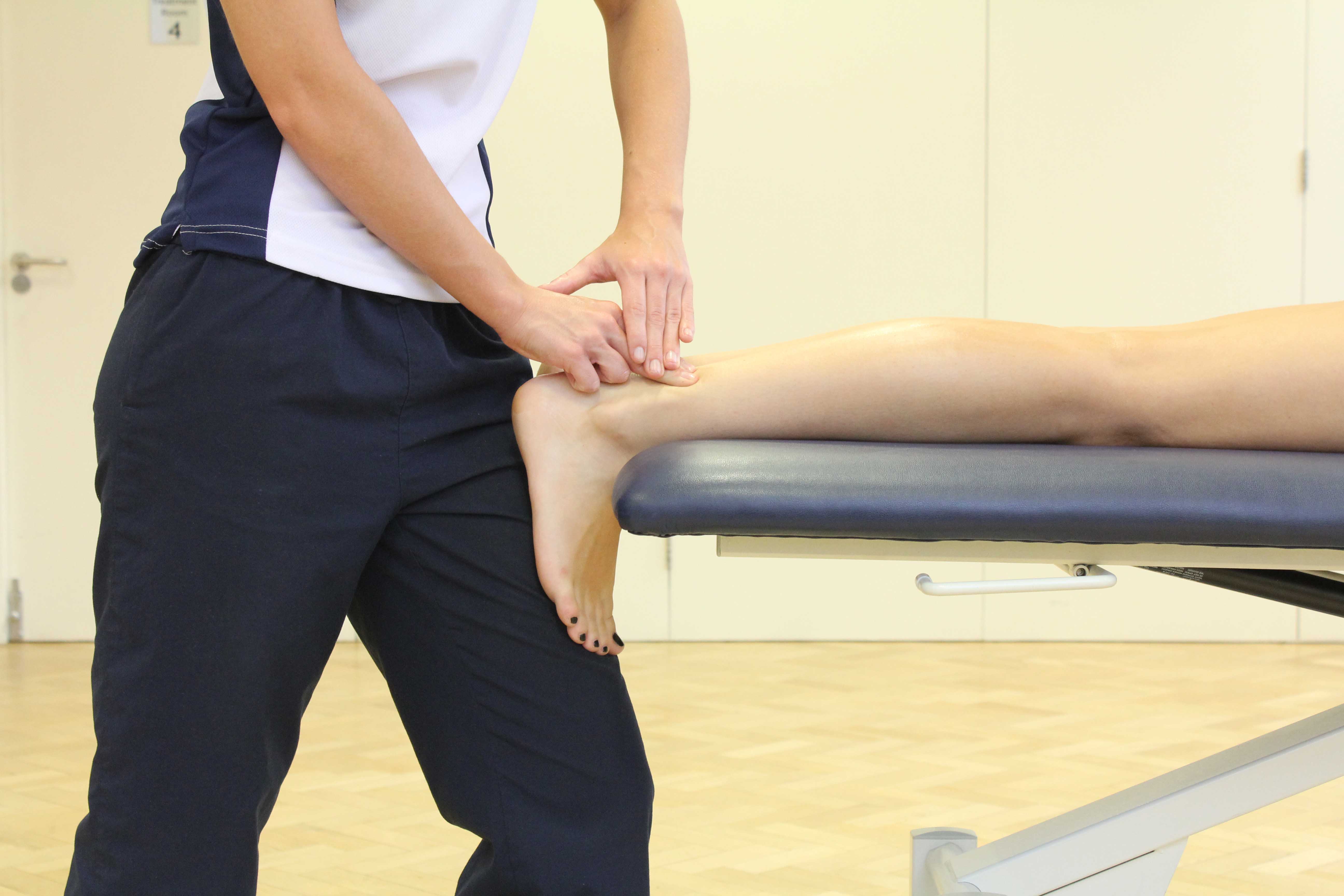 Soft tissue massage of the achilles tendon by experienced physiotherapist Soft tissue massage of the achilles tendon by experienced physiotherapist