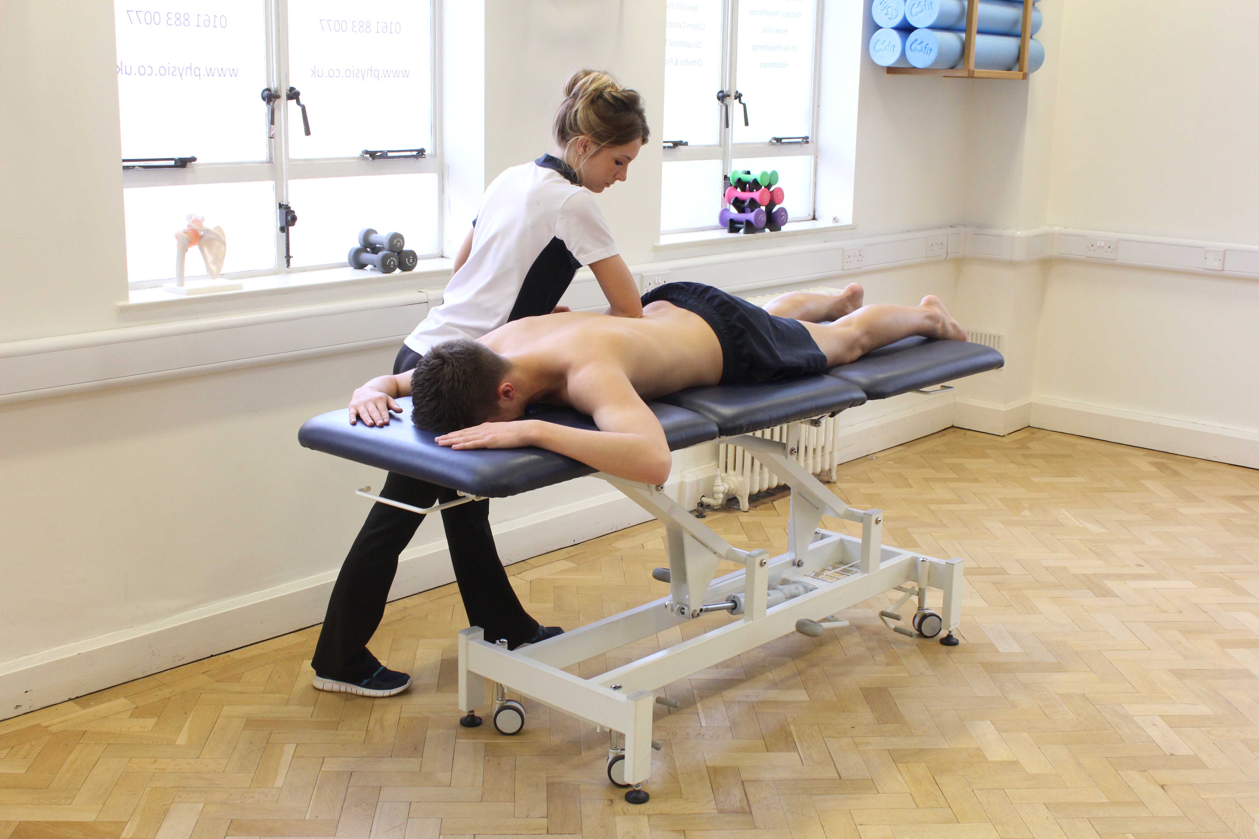 Deep tissue massage of the lower back by a specialist massage therapist