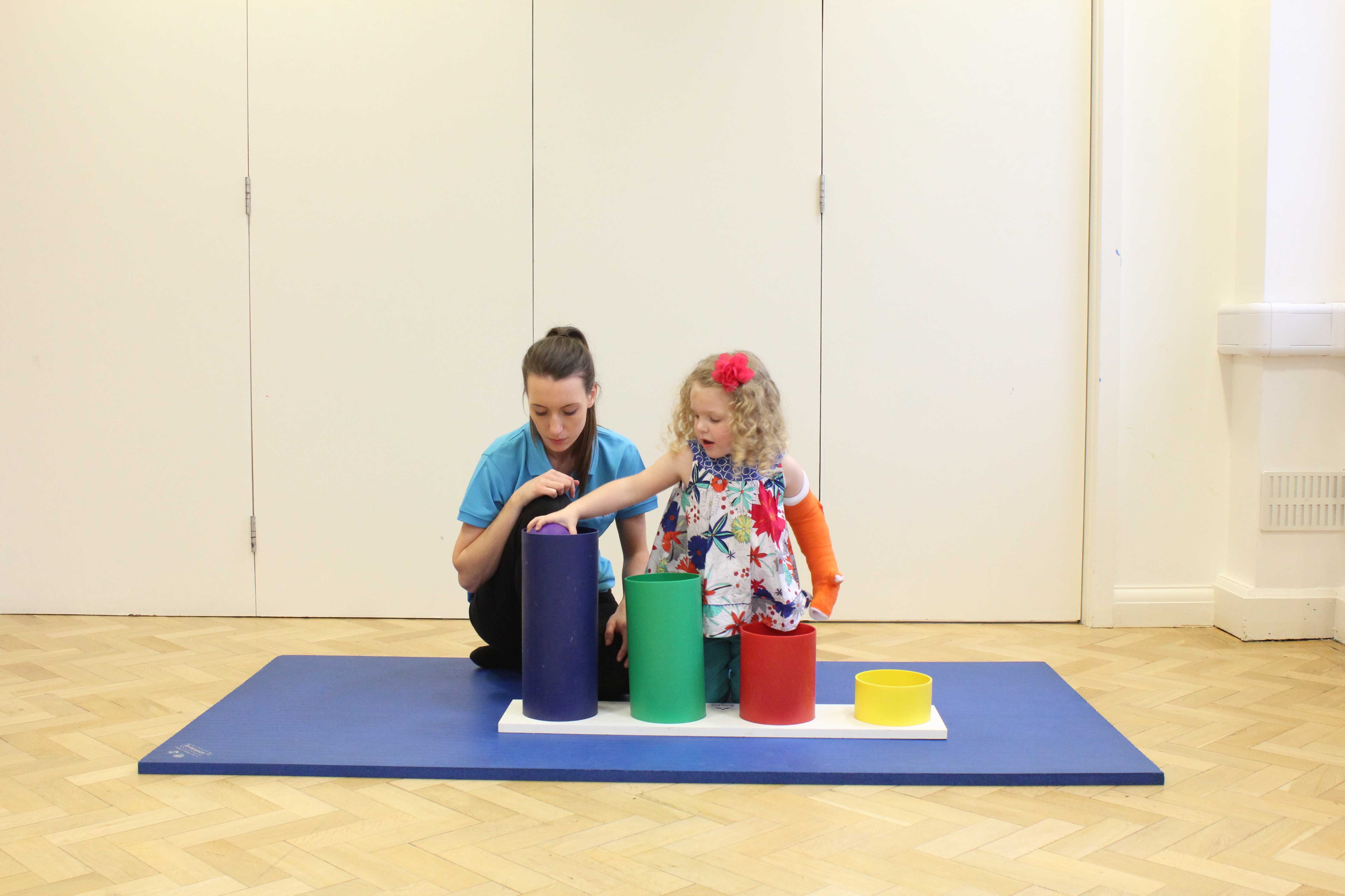 Functional exercises through play with the dominant limb constrained to promote use of the weaker side.