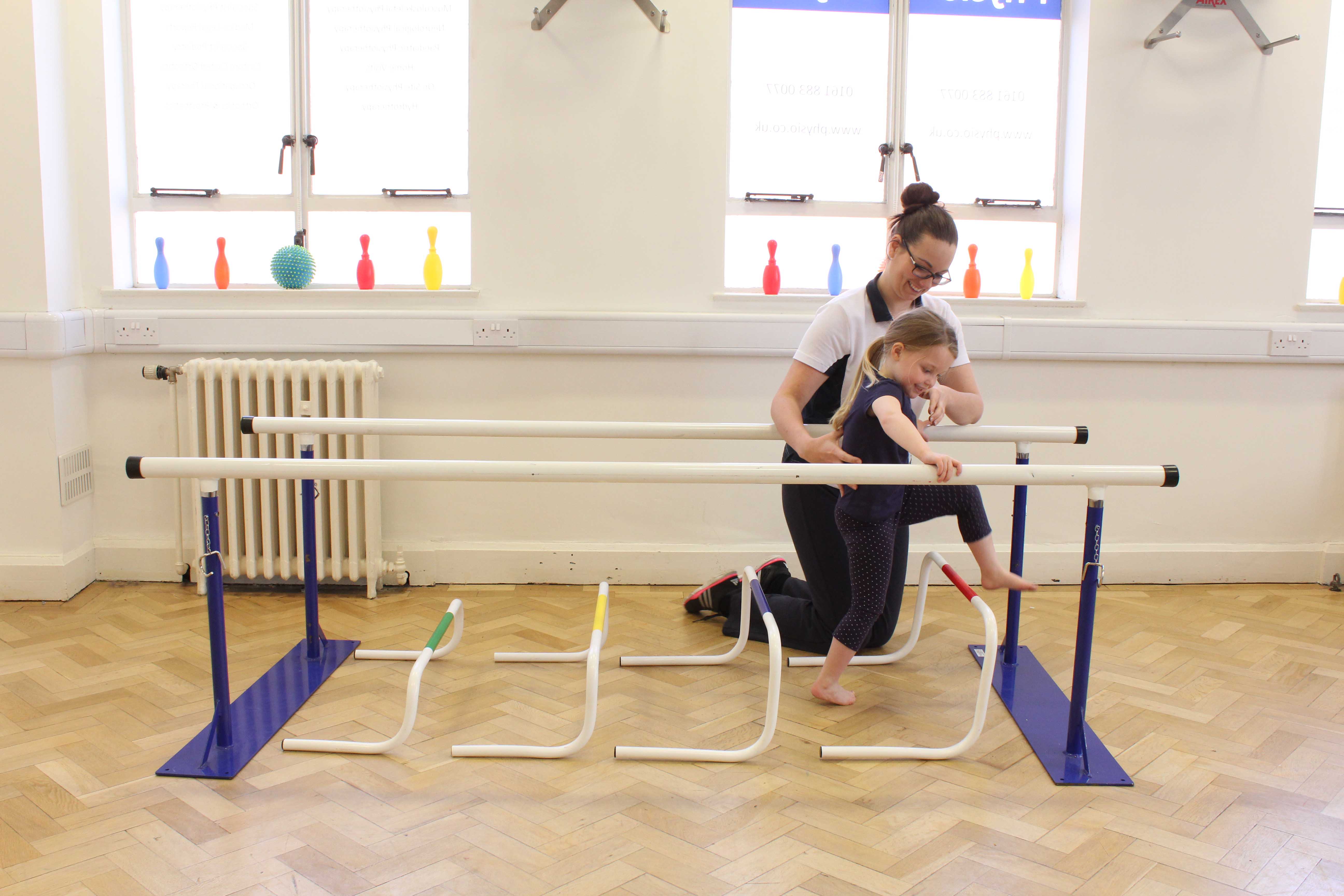 Gait re-education and mobility exercises between parallel bars, under supervision from a neurological physiotherapist Gait re-education and mobility exercises between parallel bars, under supervision from a neurological physiotherapist