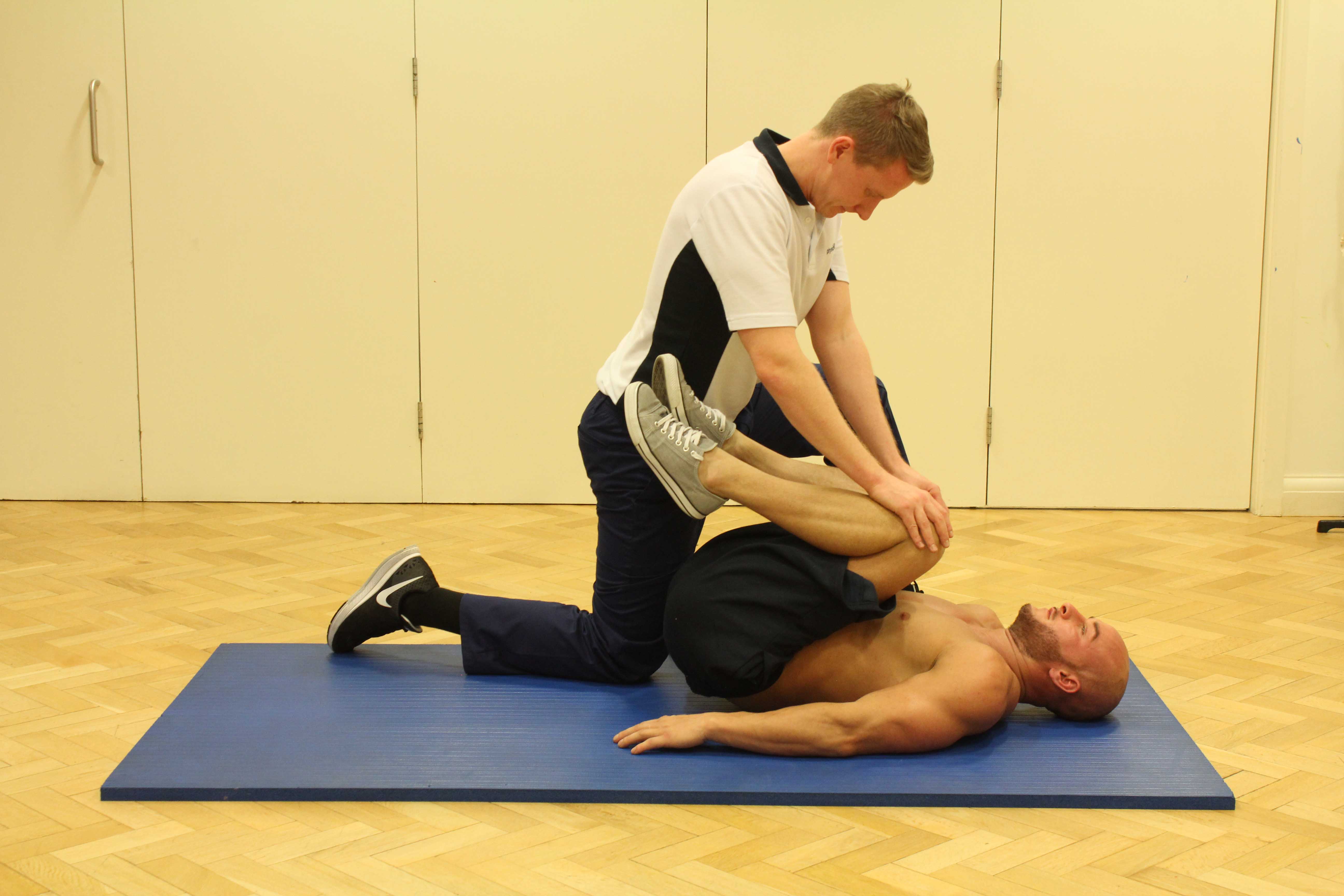 Active stretches of the upper back supervised by specialist MSK therapist Active stretches of the upper back supervised by specialist MSK therapist