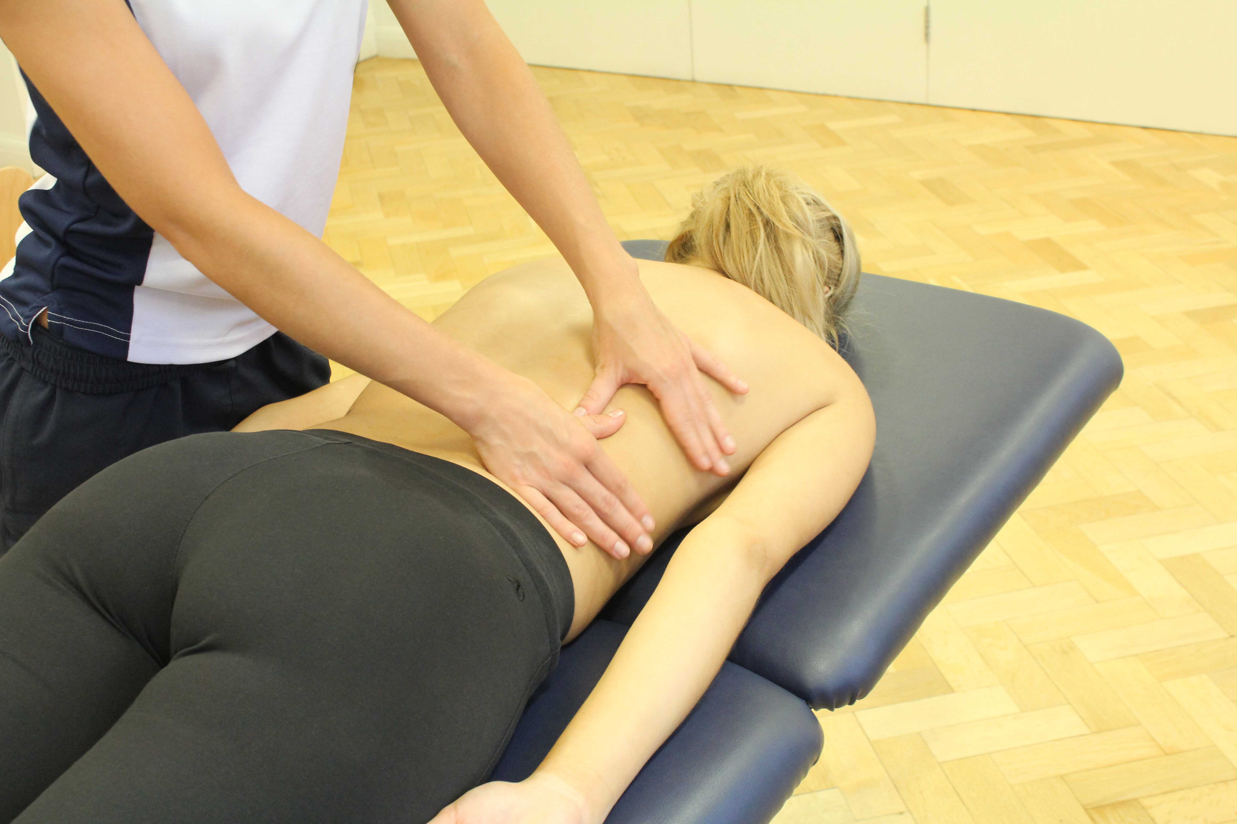 Soft tissue massage of the lower back muscles and connective tissue by specialist therapist