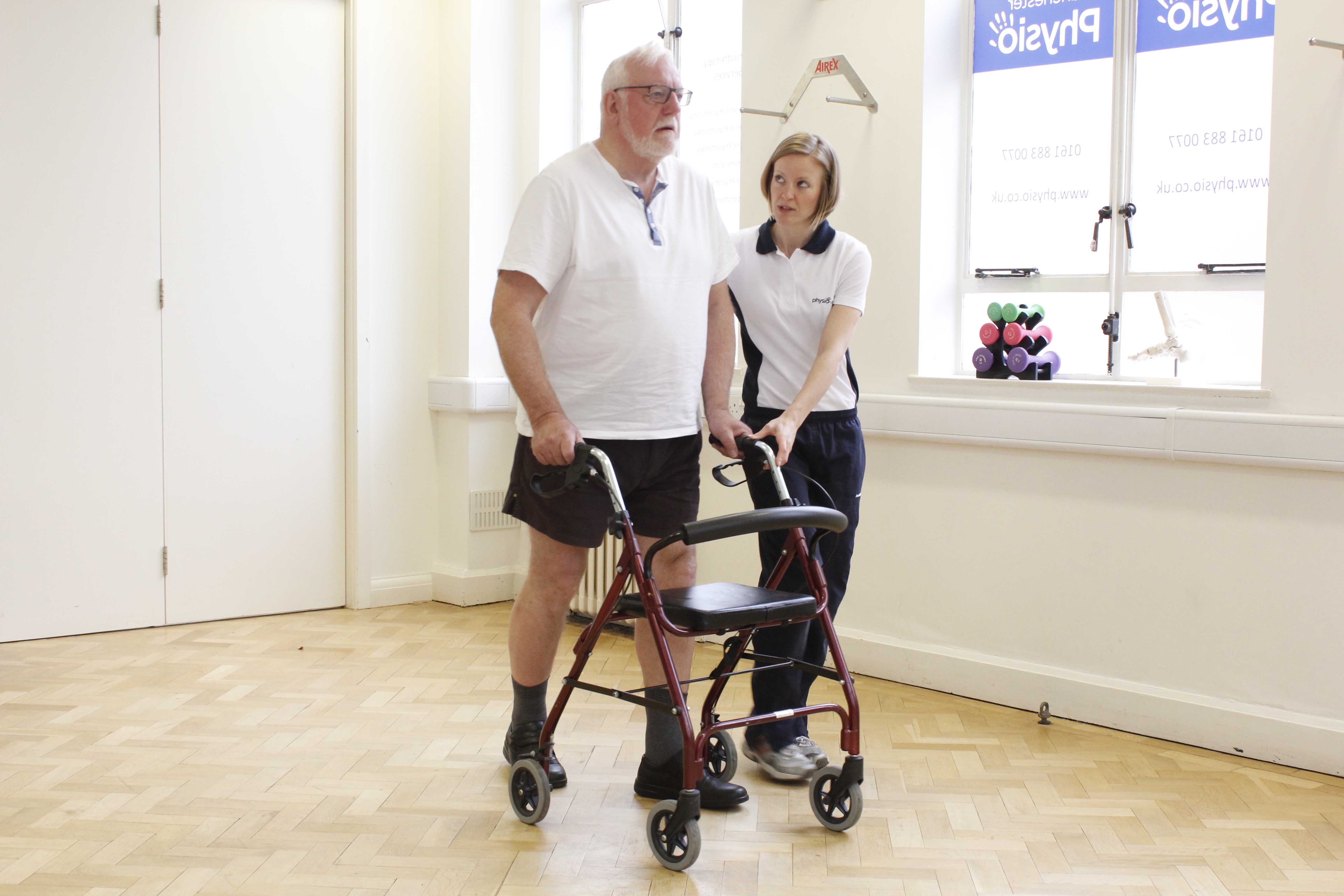Mobility exercises using a rolator frame and close supervision of a physiotherapist Mobility exercises using a rolator frame and close supervision of a physiotherapist