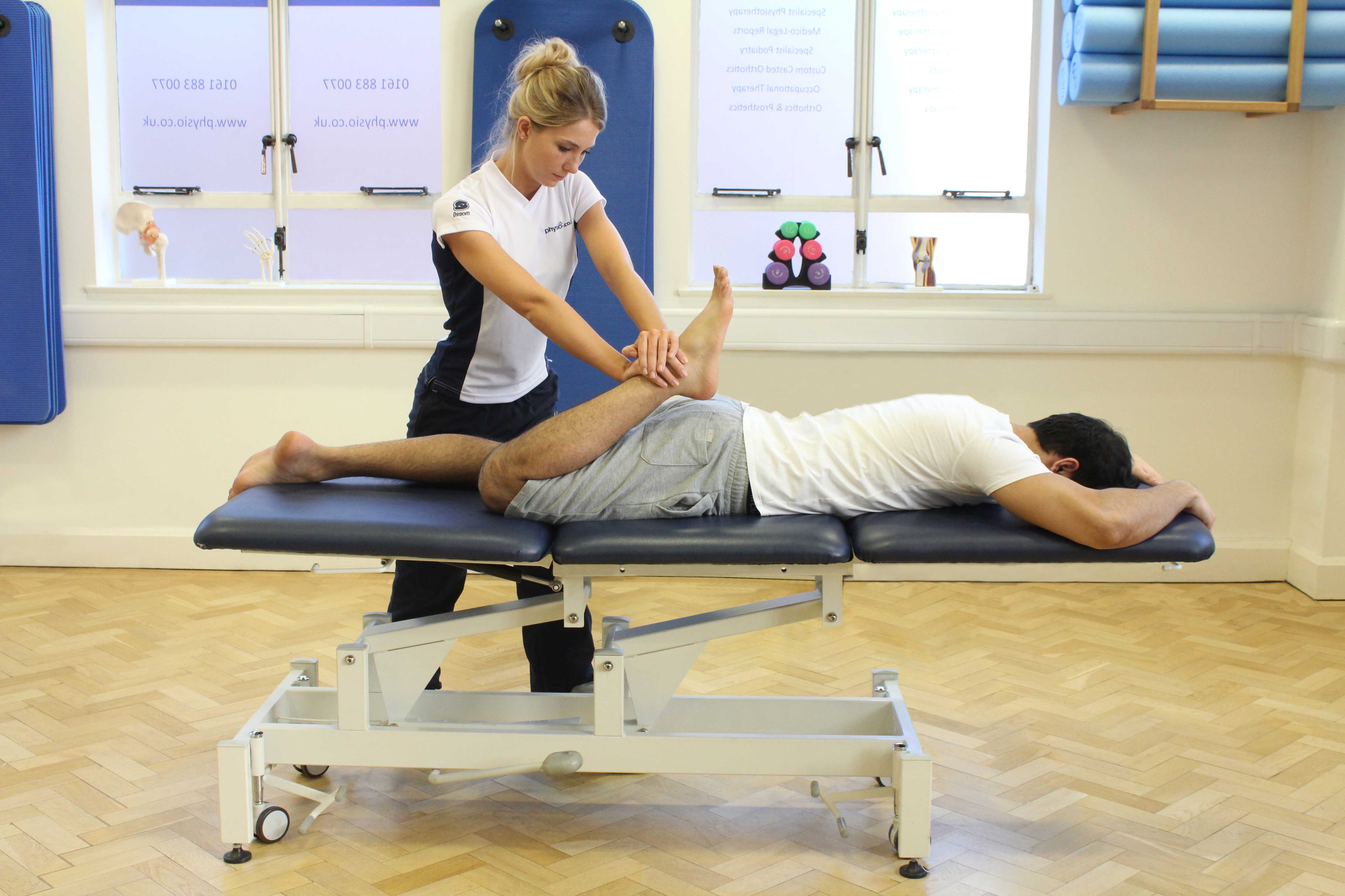 Passive stretch applied to the quadricep muscles by a specialist musculoskeletal therapist