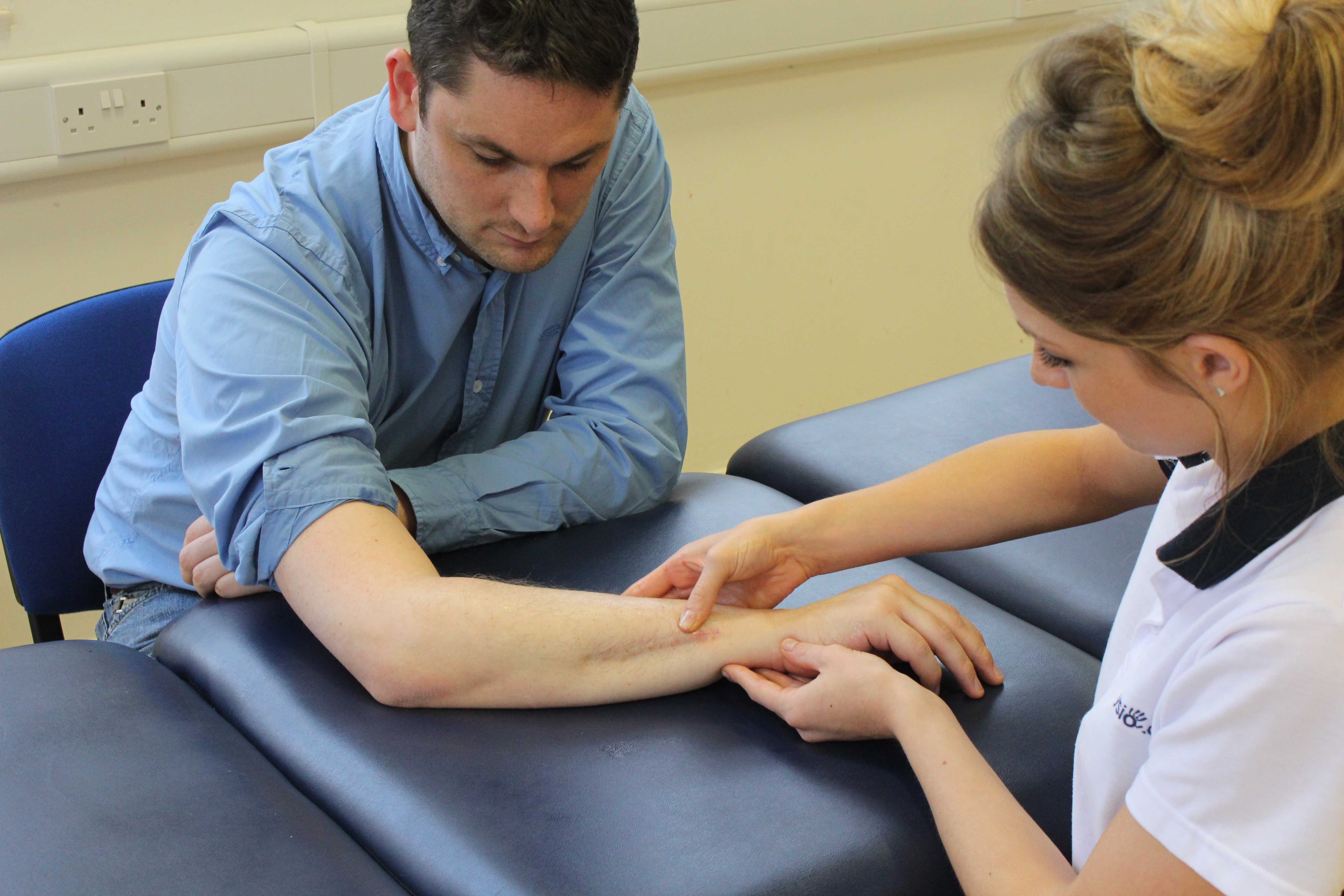 Therapist examination of wrist healing following a fracture Therapist examination of wrist healing following a fracture