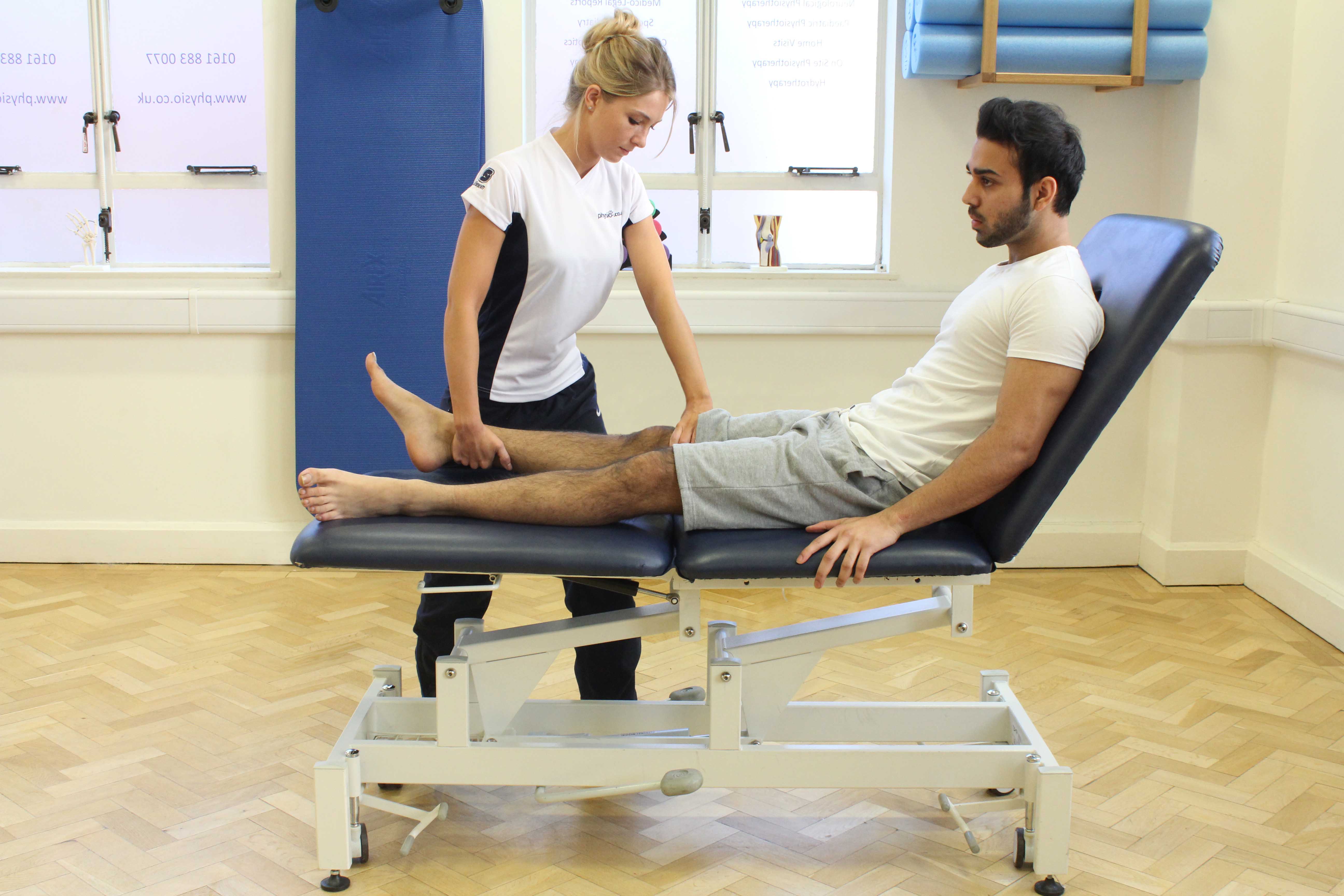 Therapist performing knee assessment