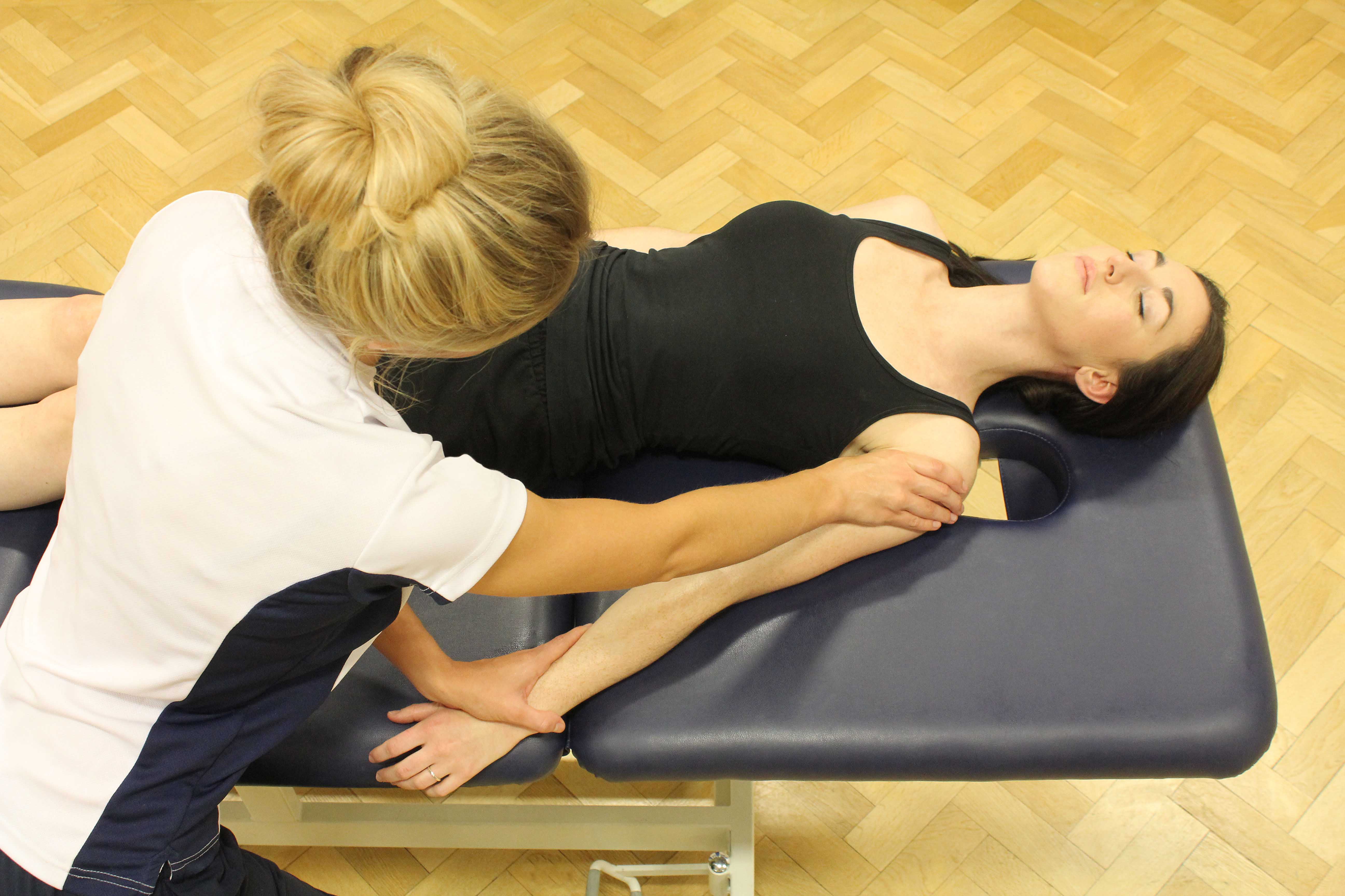 Soft tissue massage of the biceps and deltoids of the upper arm
