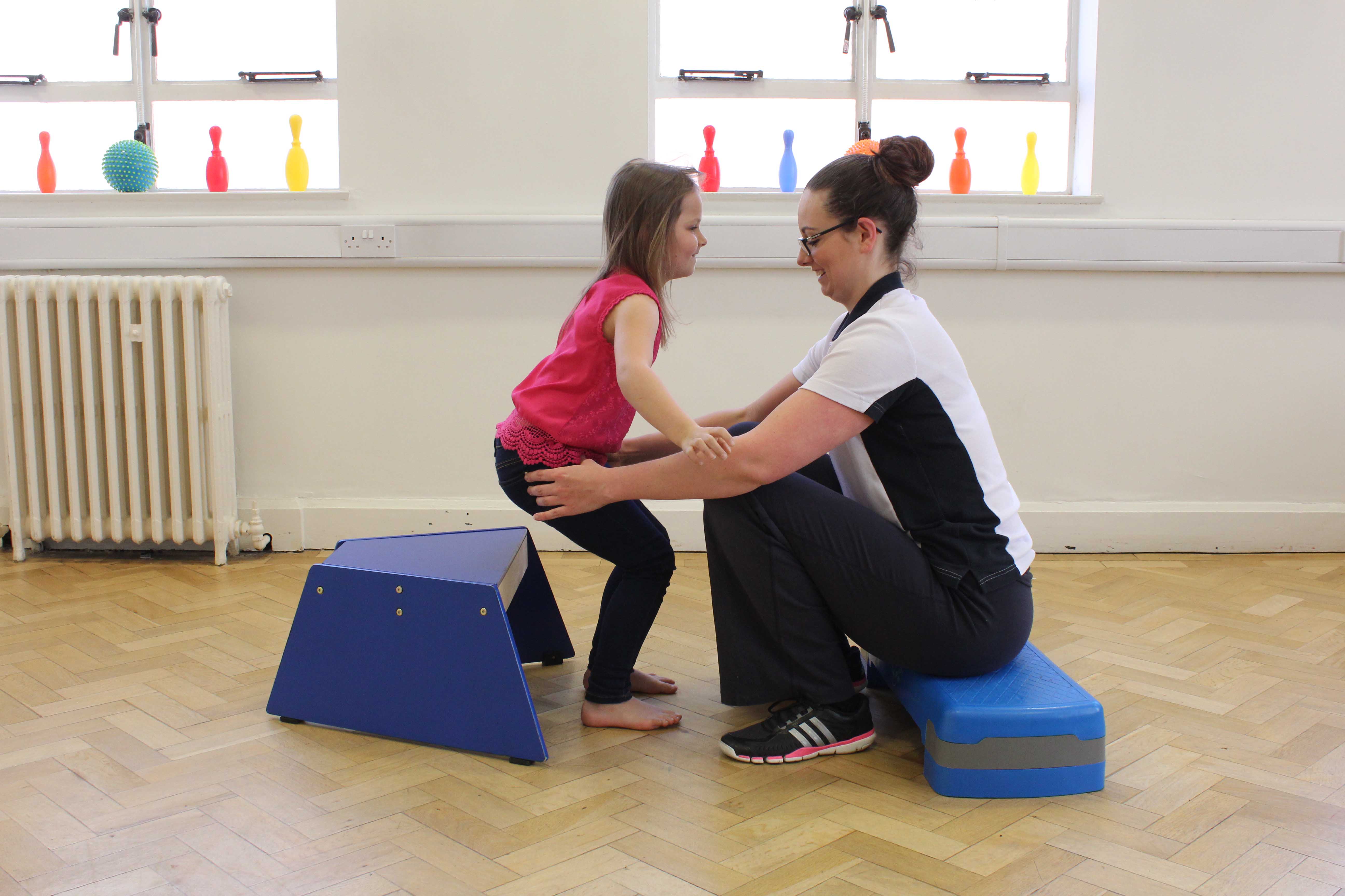 Neurological physiotherapist applying functional electrical stimulaltion treatment to aid mobility 