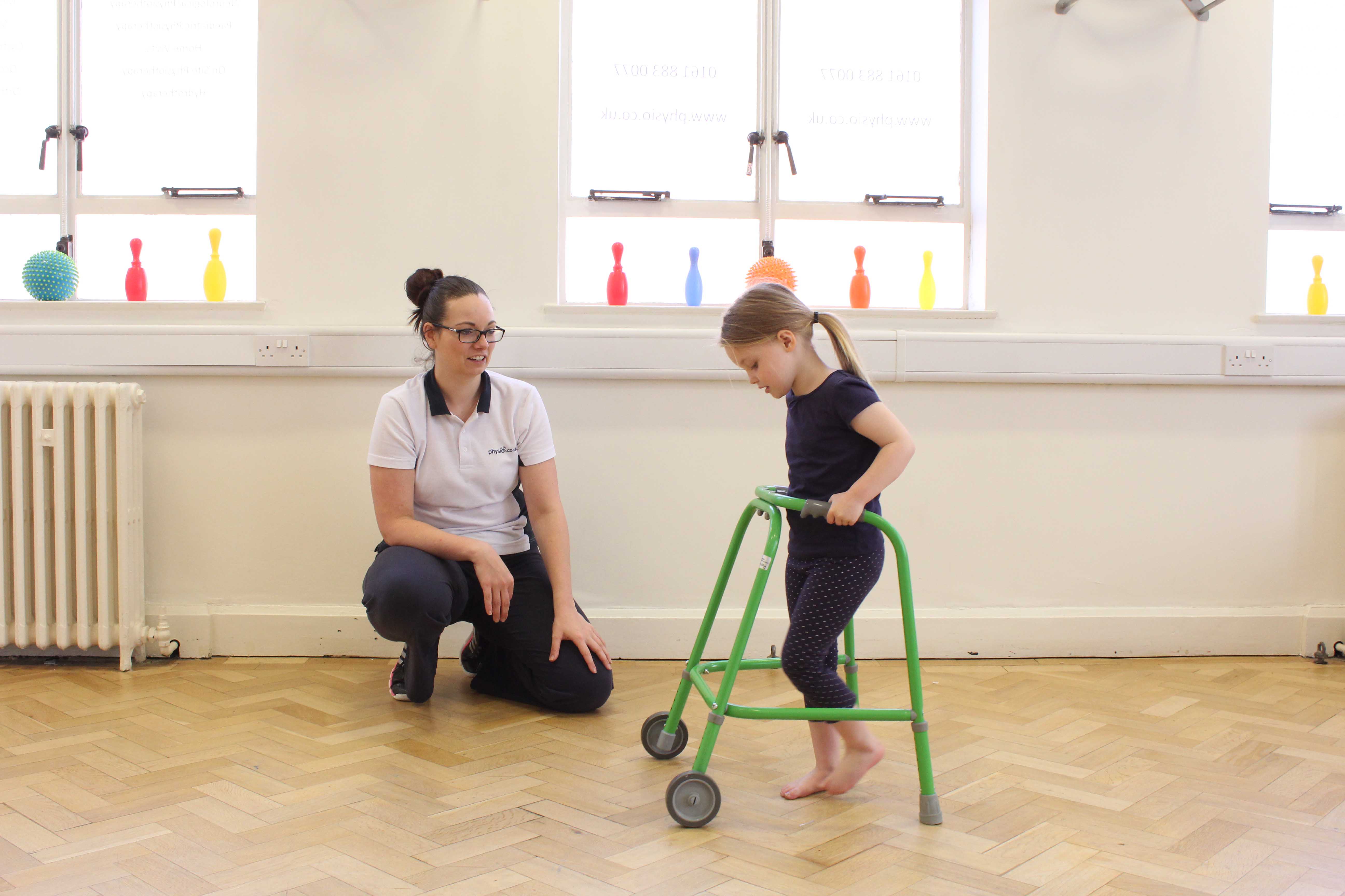 Gait re-education using a wheeled walking frame under close supervision of specilist Paediatric Physiotherapist Gait re-education using a wheeled walking frame under close supervision of specilist Paediatric Physiotherapist