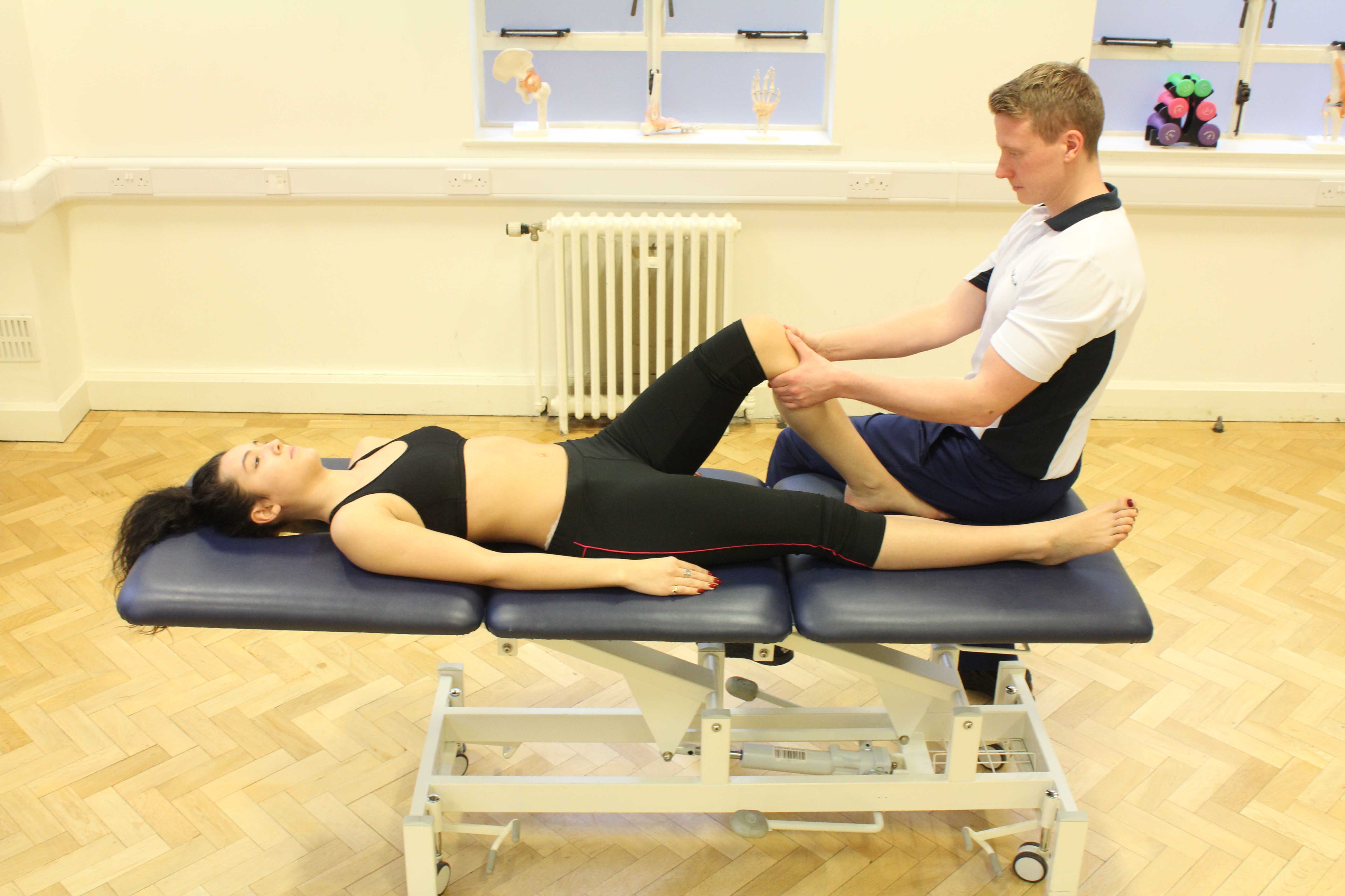 Therapist performing knee assessment