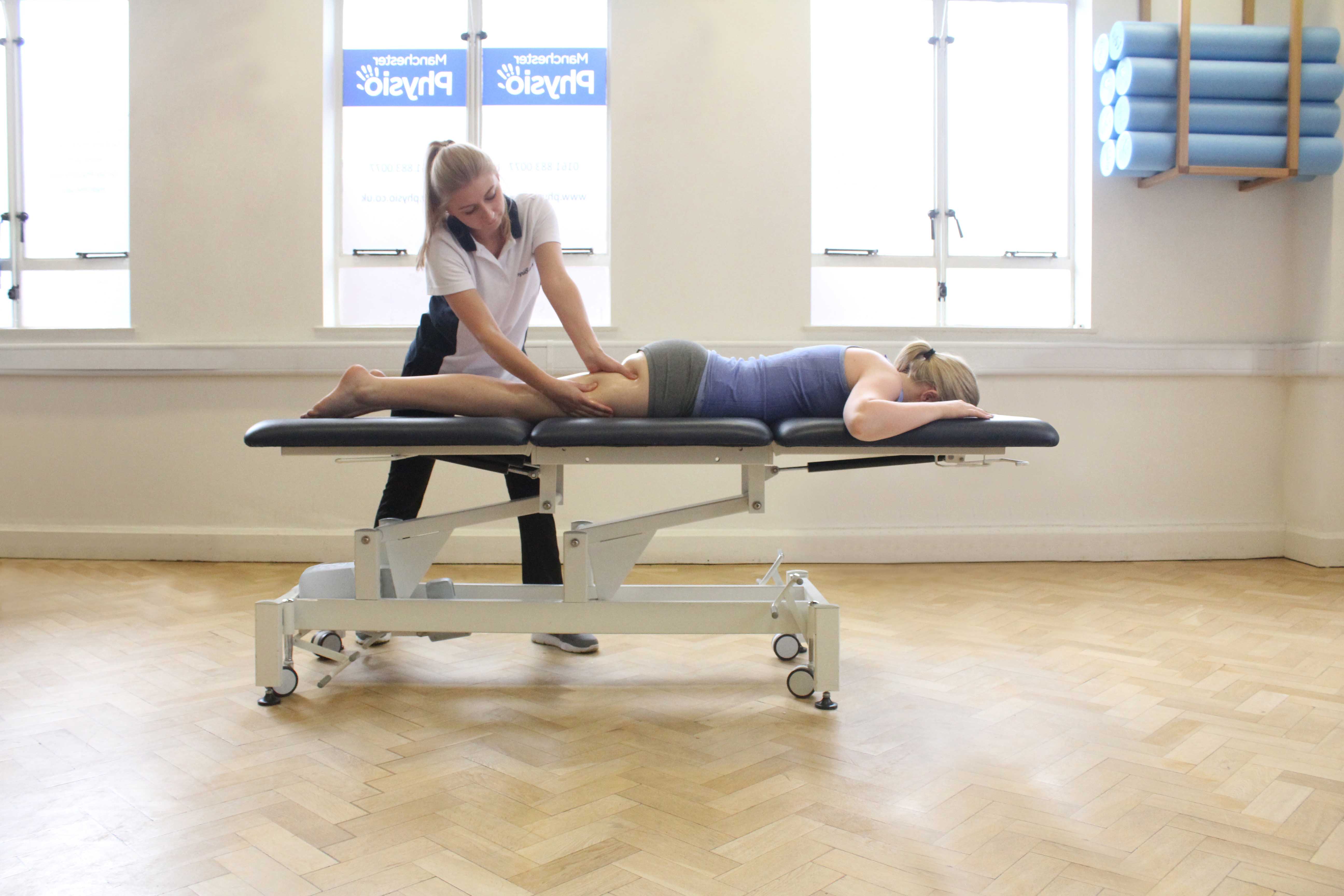 Deep tissue massage of the hamstring and gluteus muscles