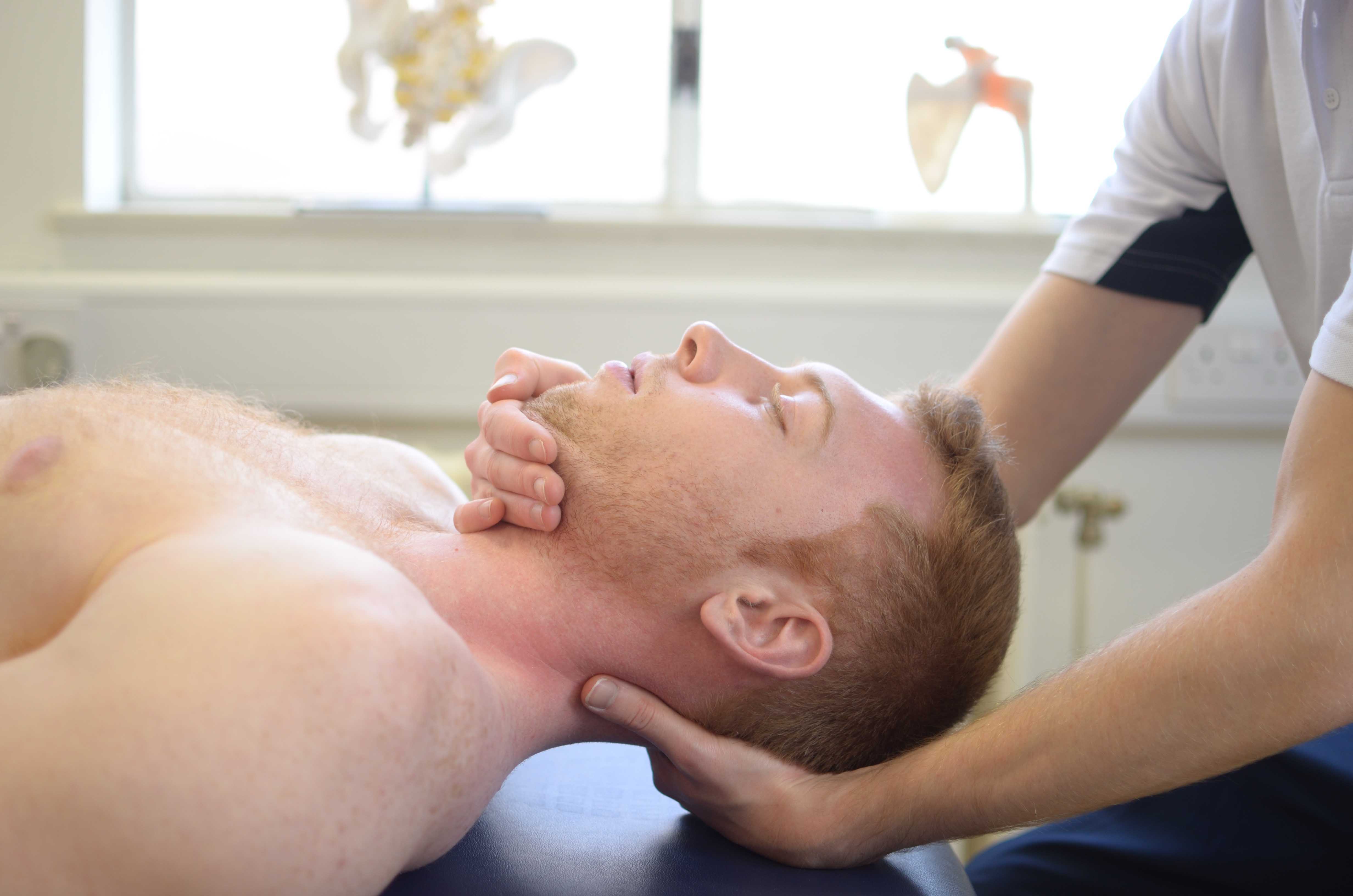 Physiotherapist led mobilisation exercises for the head.