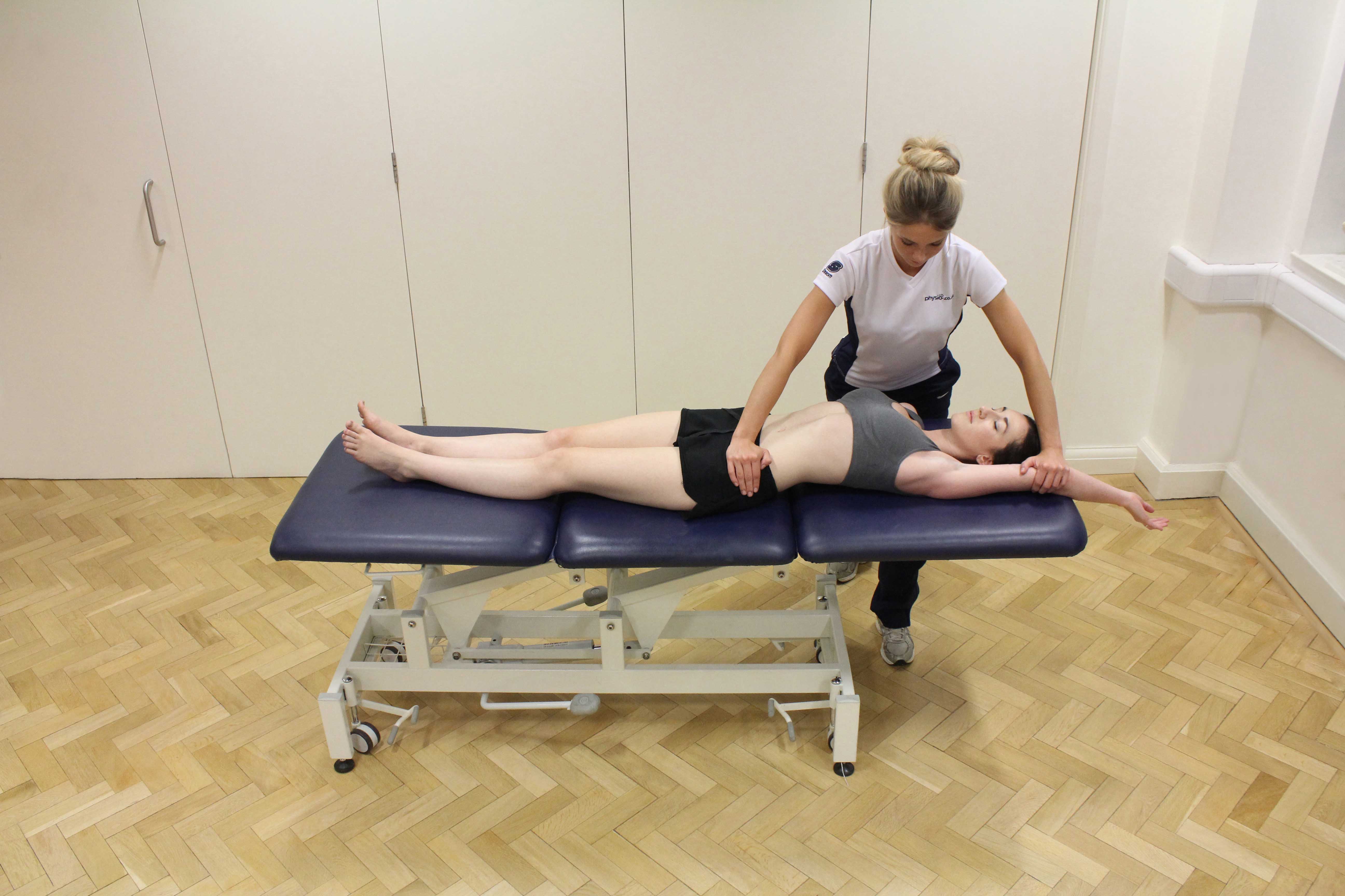 Passive stretch of the muscles and connective tissues of the hip and pelvis by specialist therapist