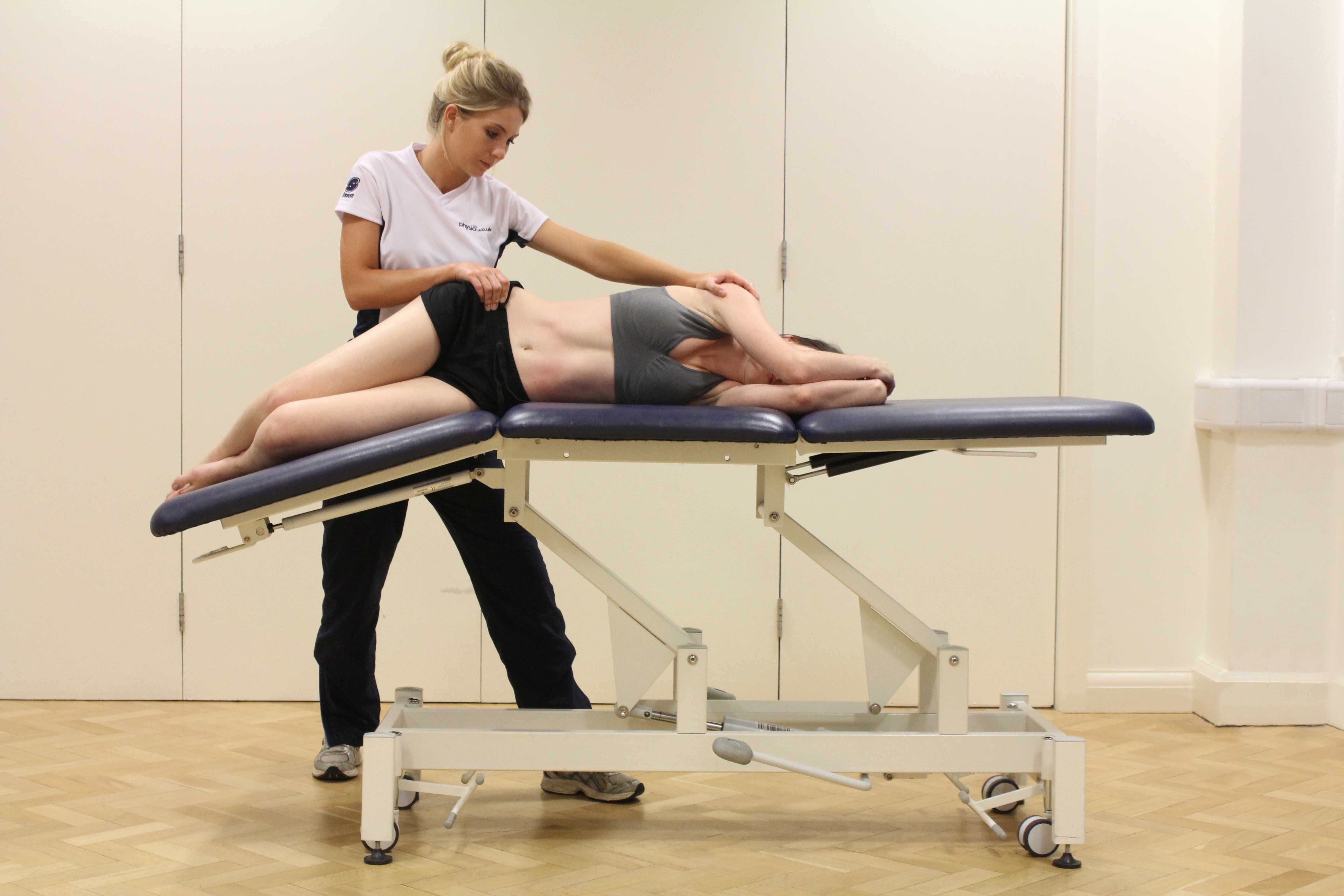 Passive stretch of the muscles and connective tissues of the hip by specialist therapist