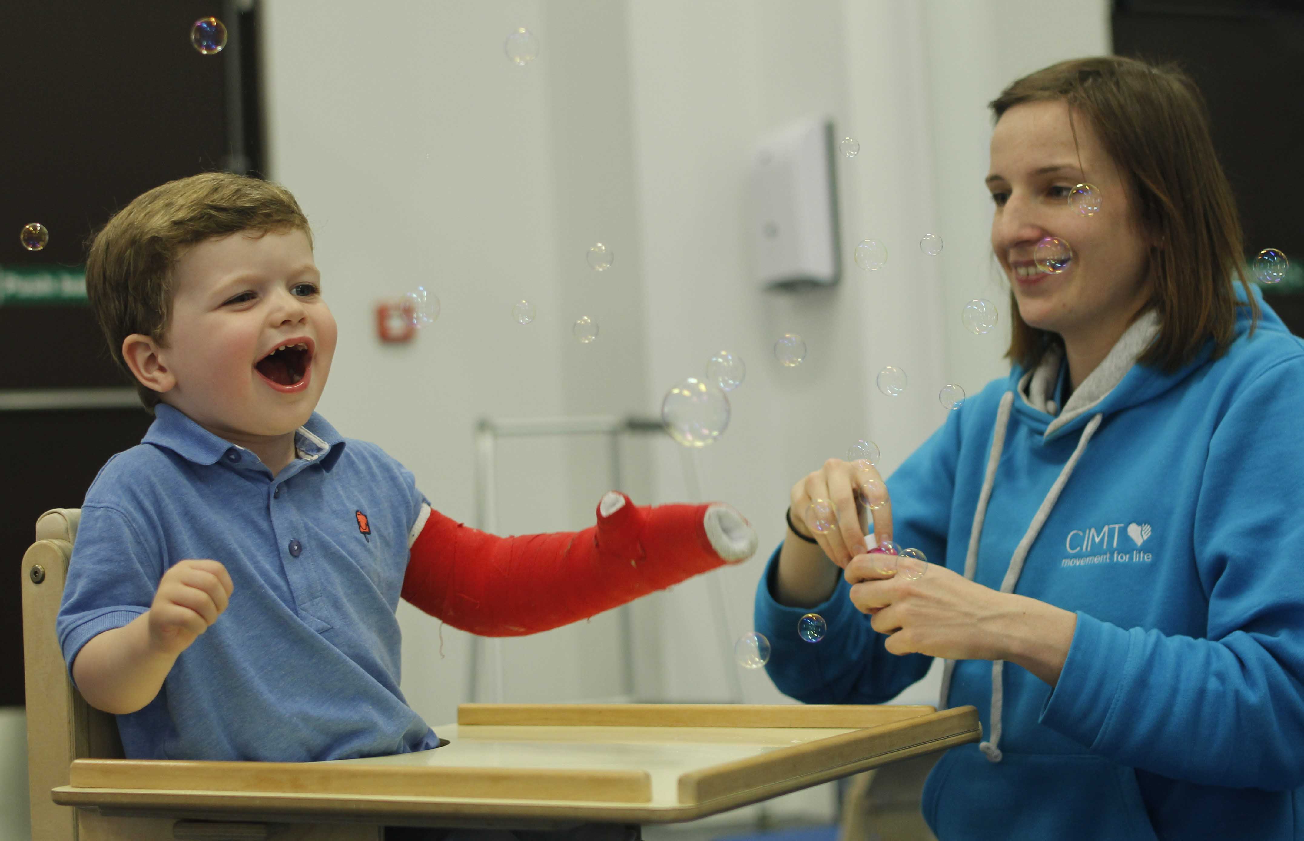 Our physiotherapist enjoying a CIMT session with our lovely little client.