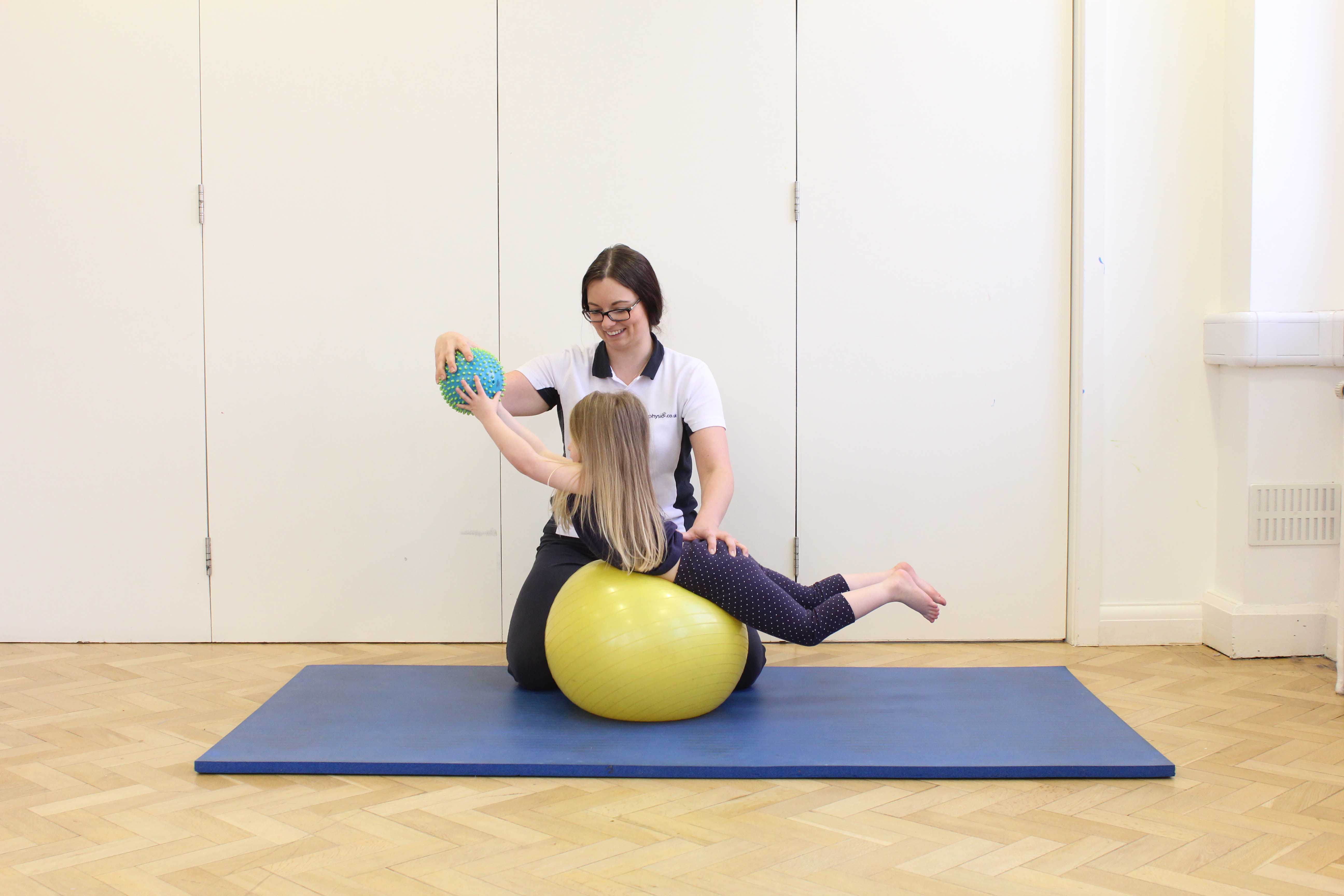 Stretching and toning exercises assisted by a paediatric physiotherapist Stretching and toning exercises assisted by a paediatric physiotherapist
