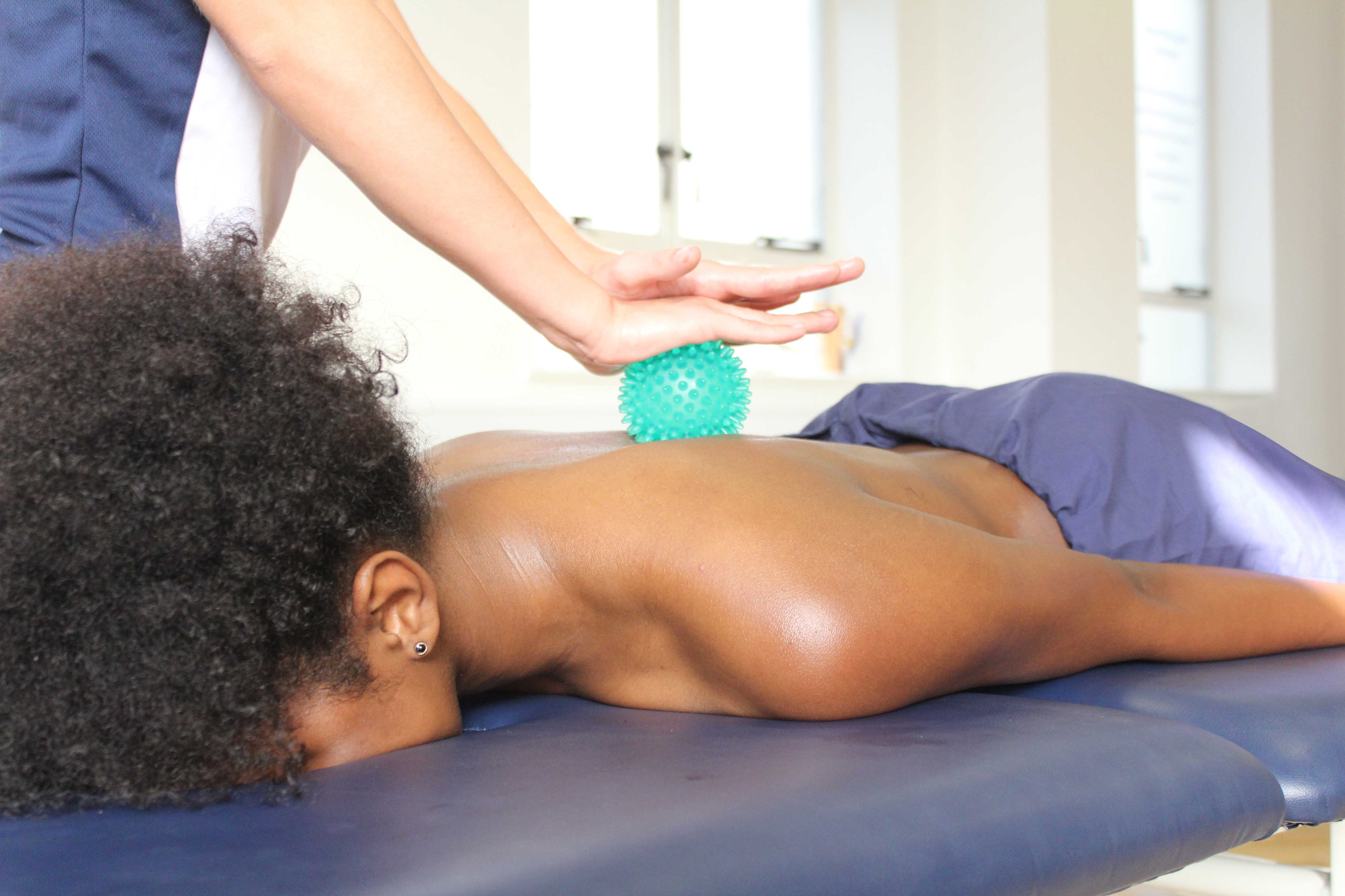 Soft tissue massage of the lower back muscles and connective tissue by specialist therapist