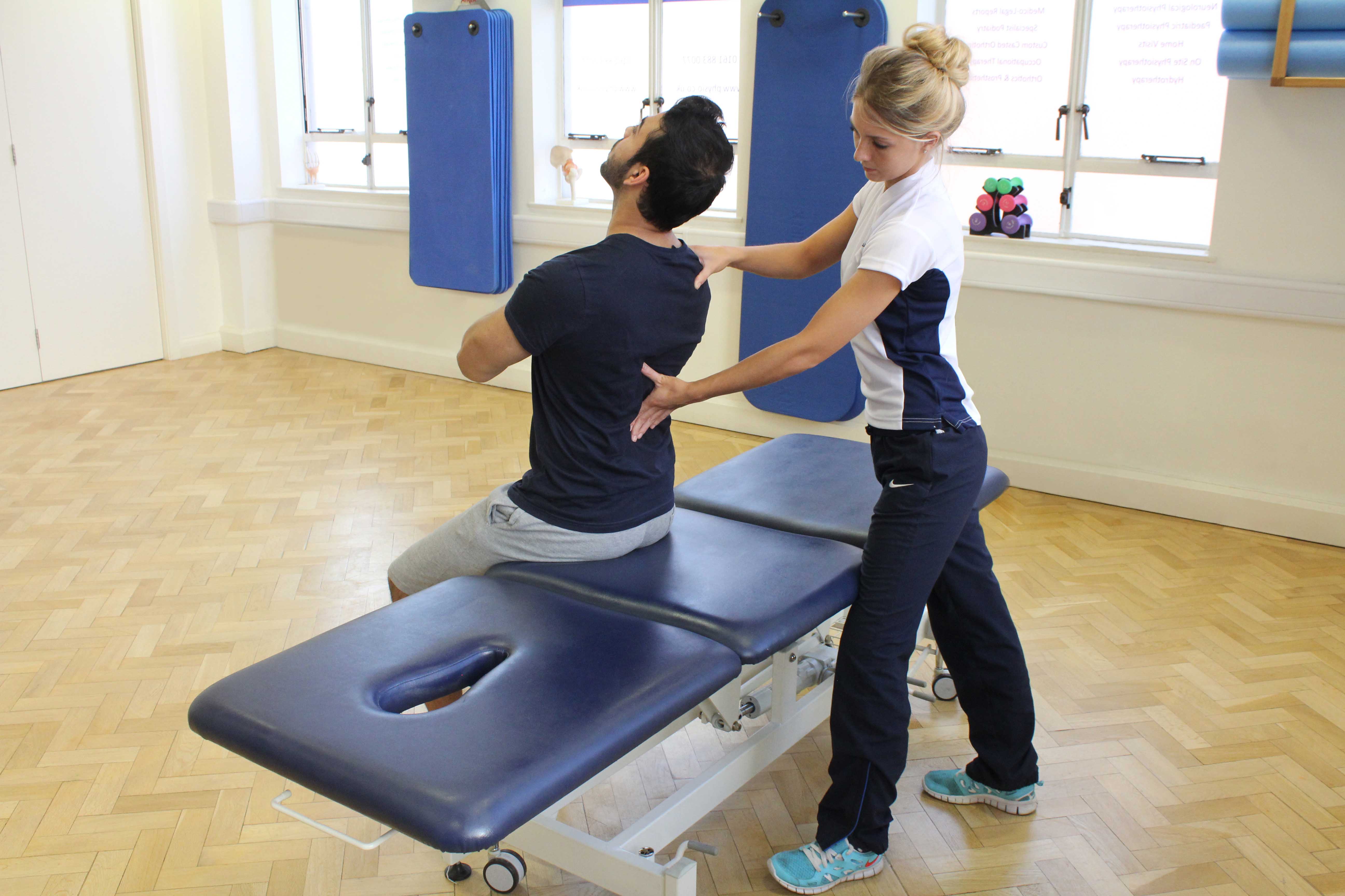 Therapist coaching client on thier postural alignment Therapist coaching client on thier postural alignment