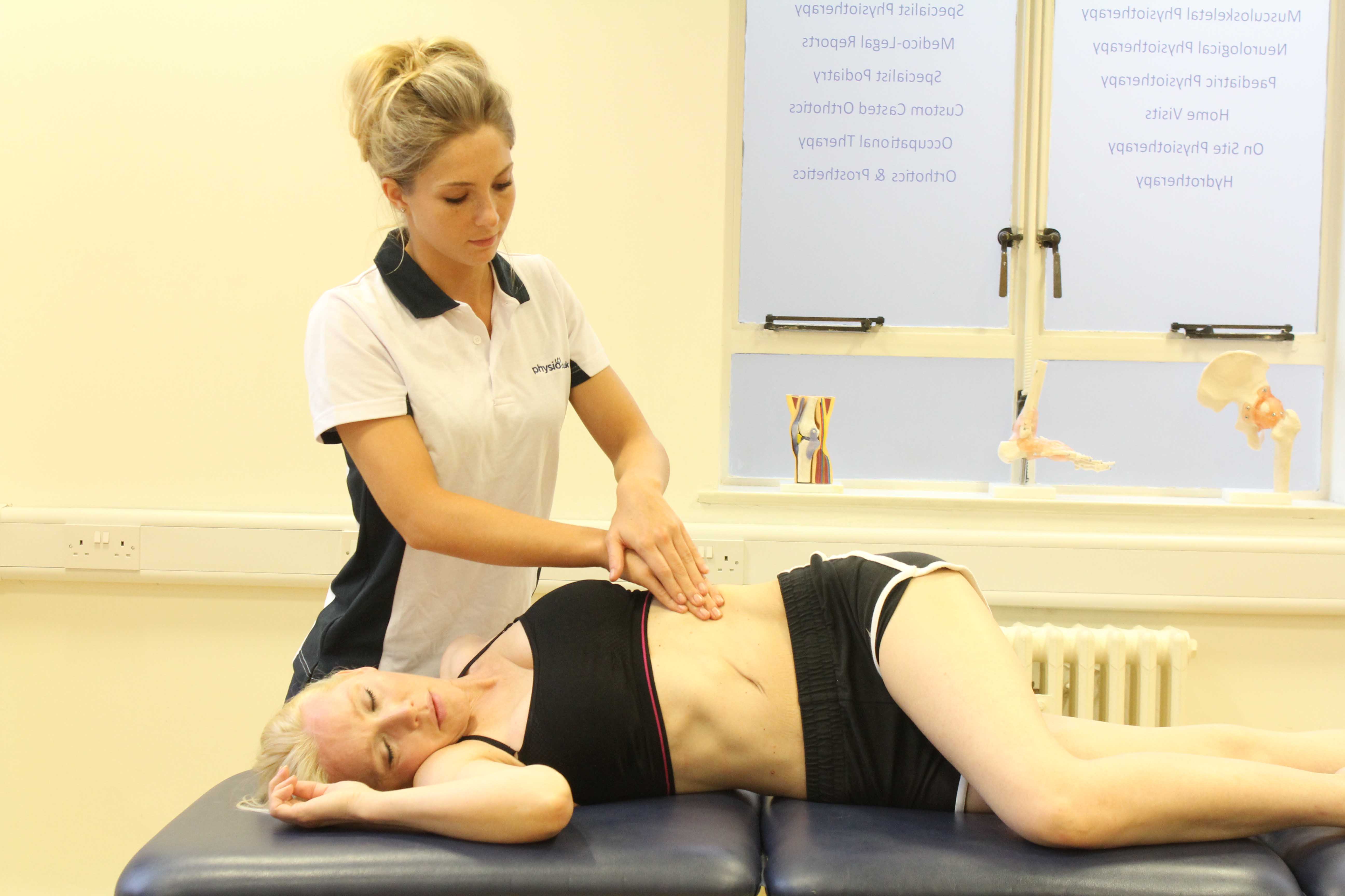 Soft tissue massage of the abdominal muscles by an experienced therapist Soft tissue massage of the abdominal muscles by an experienced therapist