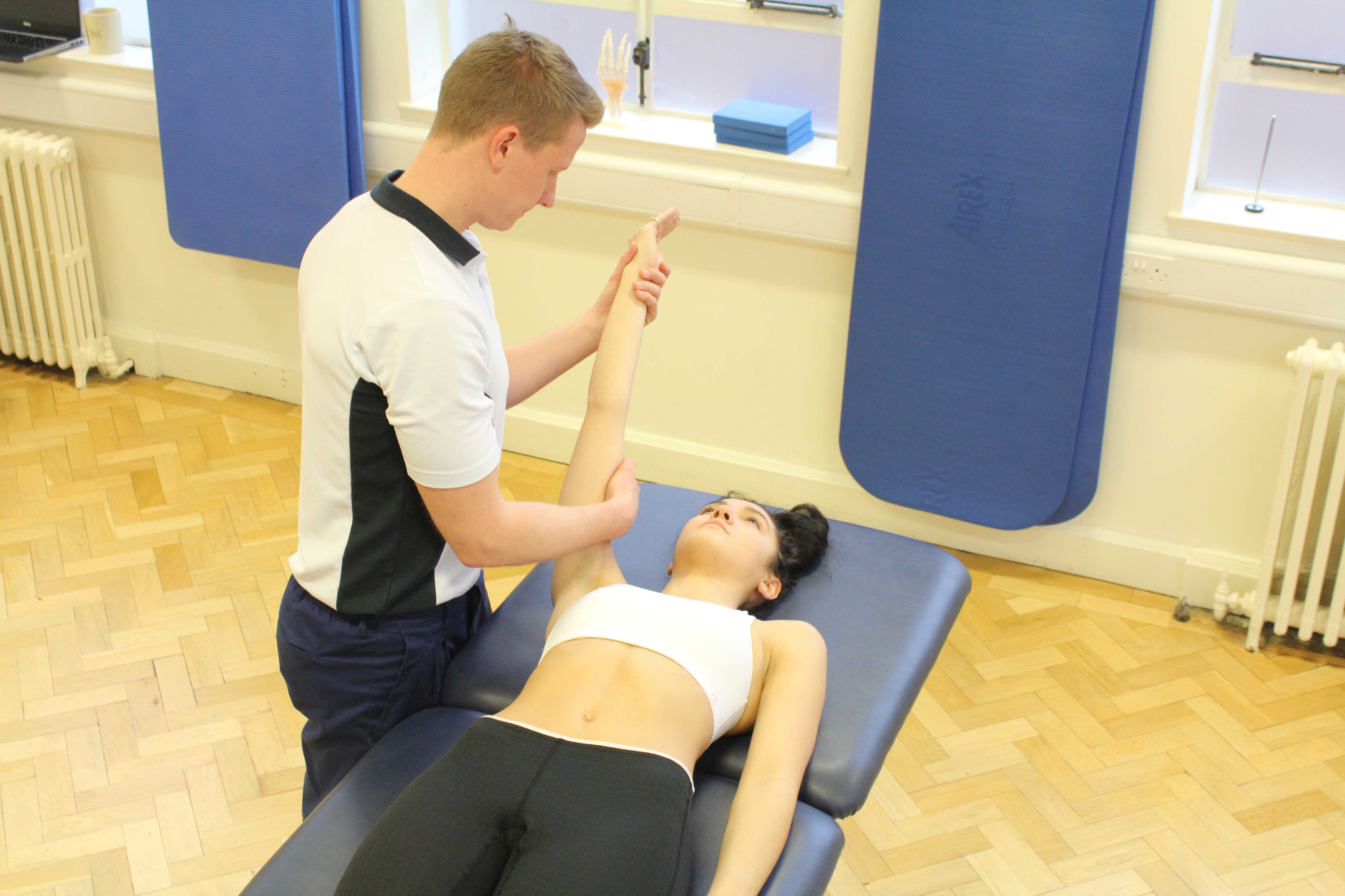Experienced musculoskeletal physiotherapist assessing a limitation in shoulder movement Experienced musculoskeletal physiotherapist assessing a limitation in shoulder movement