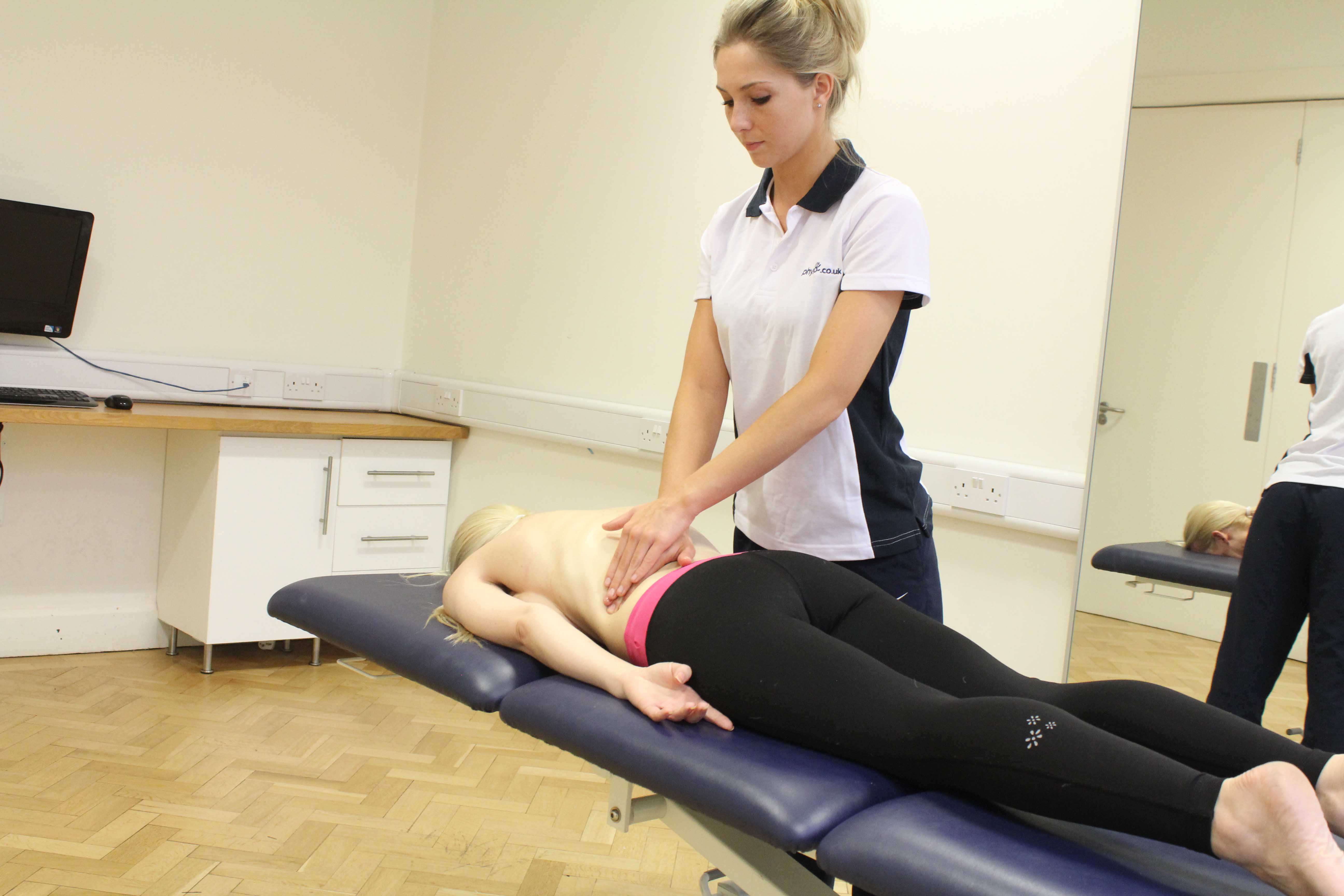Soft tissue massage of the lower back muscles and connective tissue by specialist therapist