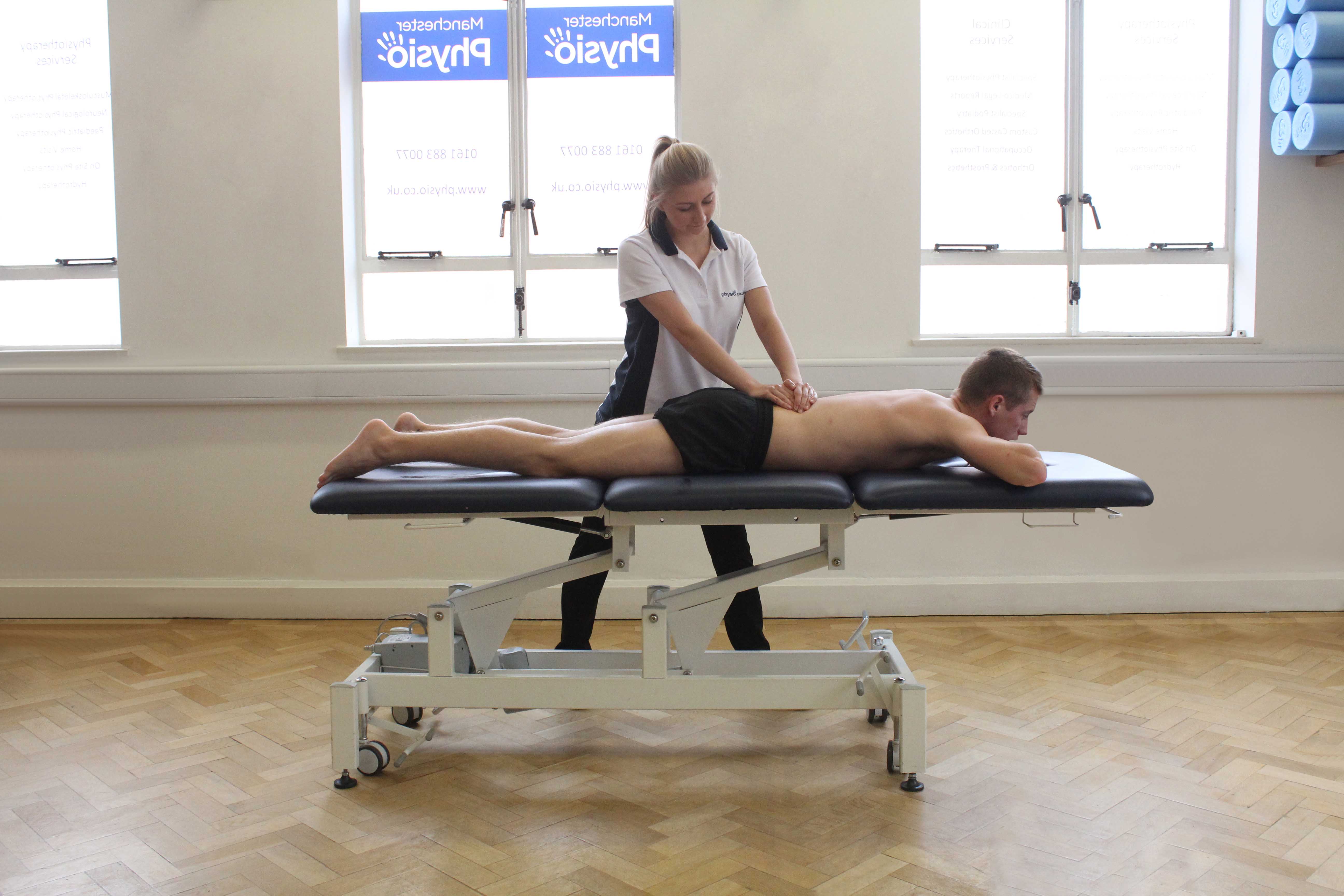 Soft tissue massage of lower latissimus dorsi muscle