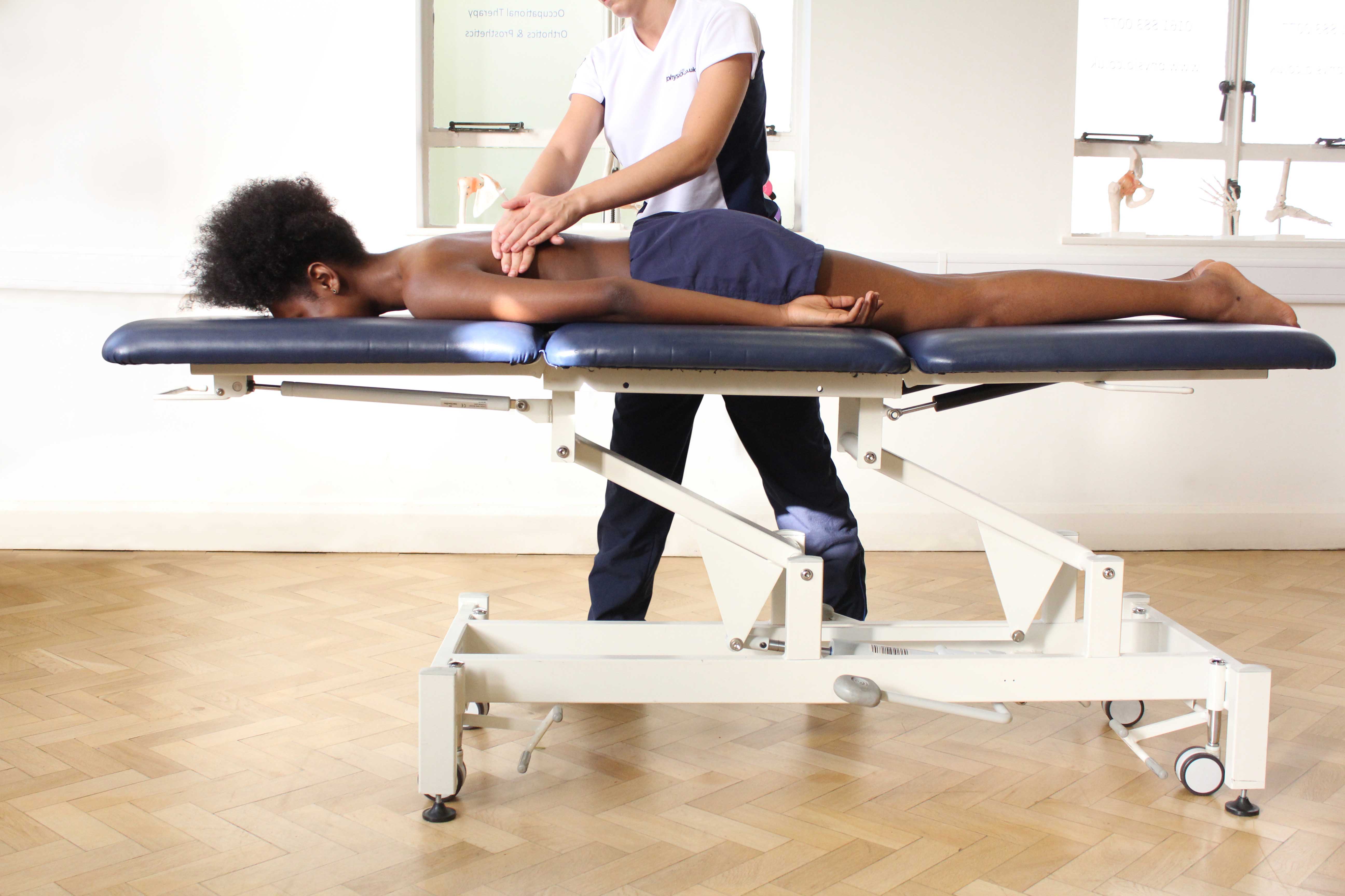 Soft tissue massage of the lower back muscles and connective tissue by specialist therapist