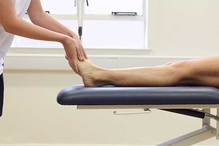 Customer receiving foot massage in relaxed position in Manchester Physio Clinic