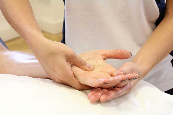 Customer Receiving Hand Massage in Manchester Physio Clinic
