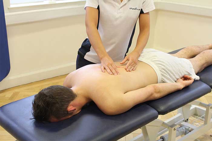 Customer receiving lower back massage in Manchester Physio Clinic